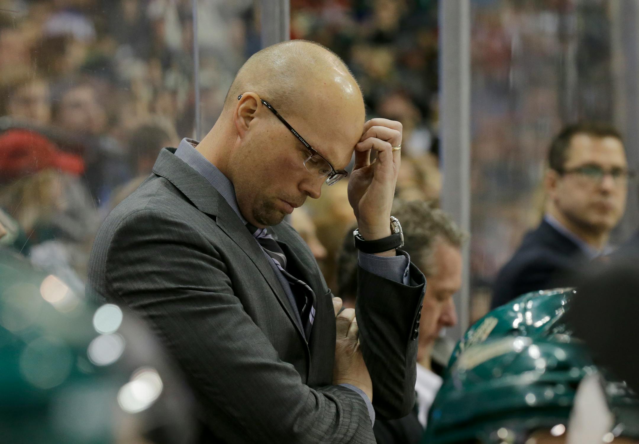 Minnesota Wild head coach Mike Yeo rubs his forehead during the third period of an NHL hockey game against the Colorado Avalanche in St. Paul, Minn., Saturday, Feb. 7, 2015. The Wild won 1-0. (AP Photo/Ann Heisenfelt)