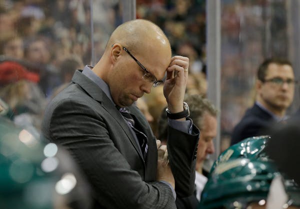 Minnesota Wild head coach Mike Yeo rubs his forehead during the third period of an NHL hockey game against the Colorado Avalanche in St. Paul, Minn., 