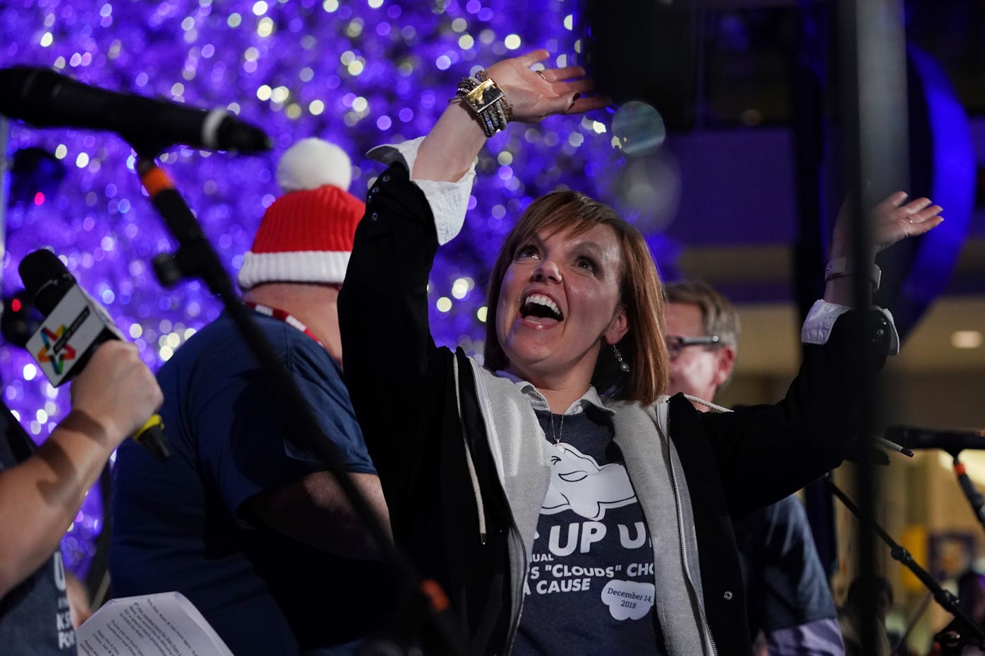 Laura and Rob Sobiech, whose son Zach's battle with cancer inspired the annual "Clouds' Choir for a Cause performance at the Mall of America, waved as they took the stage during the event.