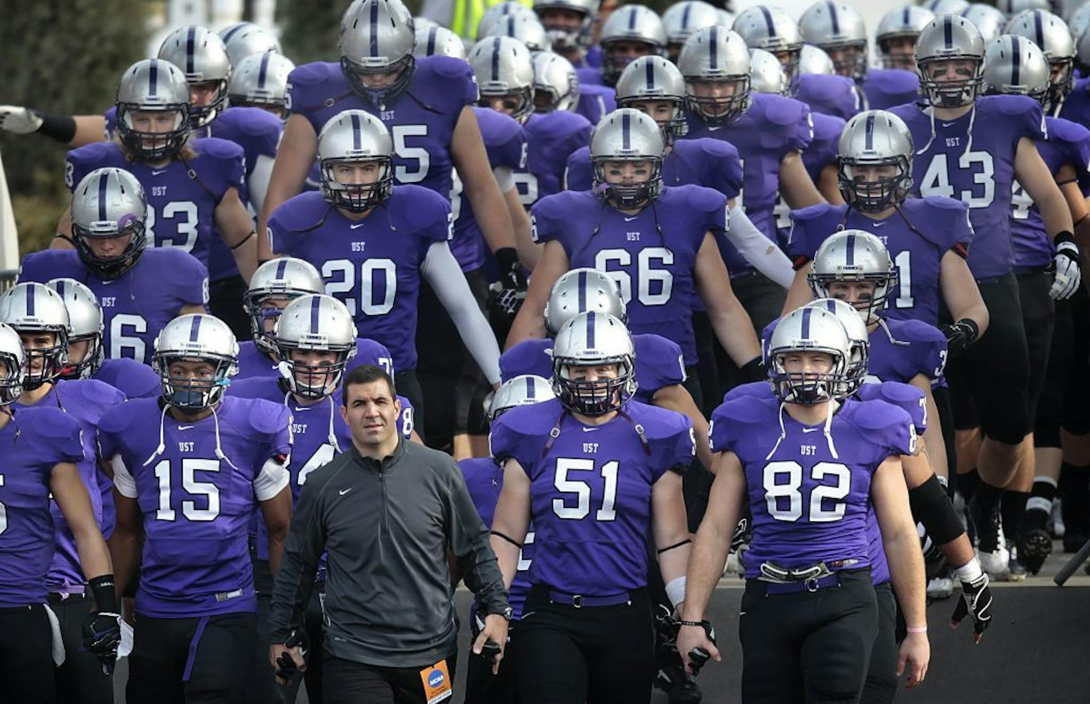 St. Thomas head football coach Glenn Caruso led his team on to the field.