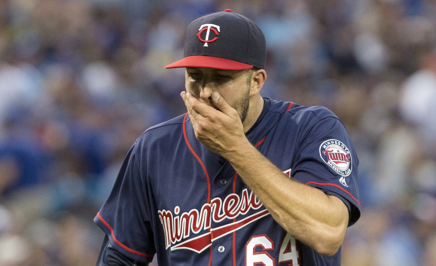 Minnesota Twins starting pitcher Pat Dean returns to the dugout at the end of the second inning after giving up five runs to the Toronto Blue Jays in baseball game action in Toronto, Friday, Aug. 26, 2016. (Chris Young/The Canadian Press via AP)