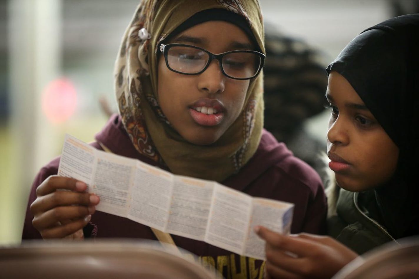 Sumaya Hanafi left,and her sister Amina Hanafi read over a pamphlet "know your rights and responsibilities as an American Muslim" during a information meeting at CAIR-MN Tuesday January 31, 2017 in Minneapolis, MN.