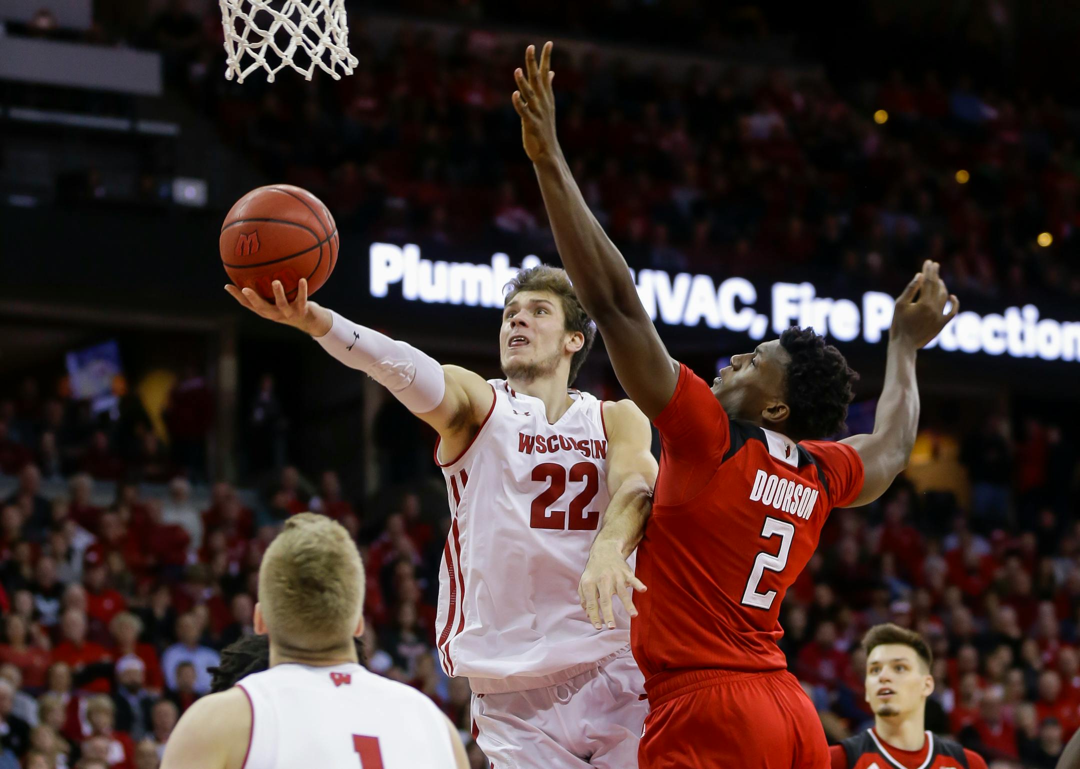 Wisconsin's Ethan Happ (22) shoots against Rutgers' Shaquille Doorson (2) during the second half of an NCAA college basketball game Monday, Dec. 3, 2018, in Madison, Wis. Happ had a game-high 20 in Wisconsin's 69-64 win. (AP Photo/Andy Manis)