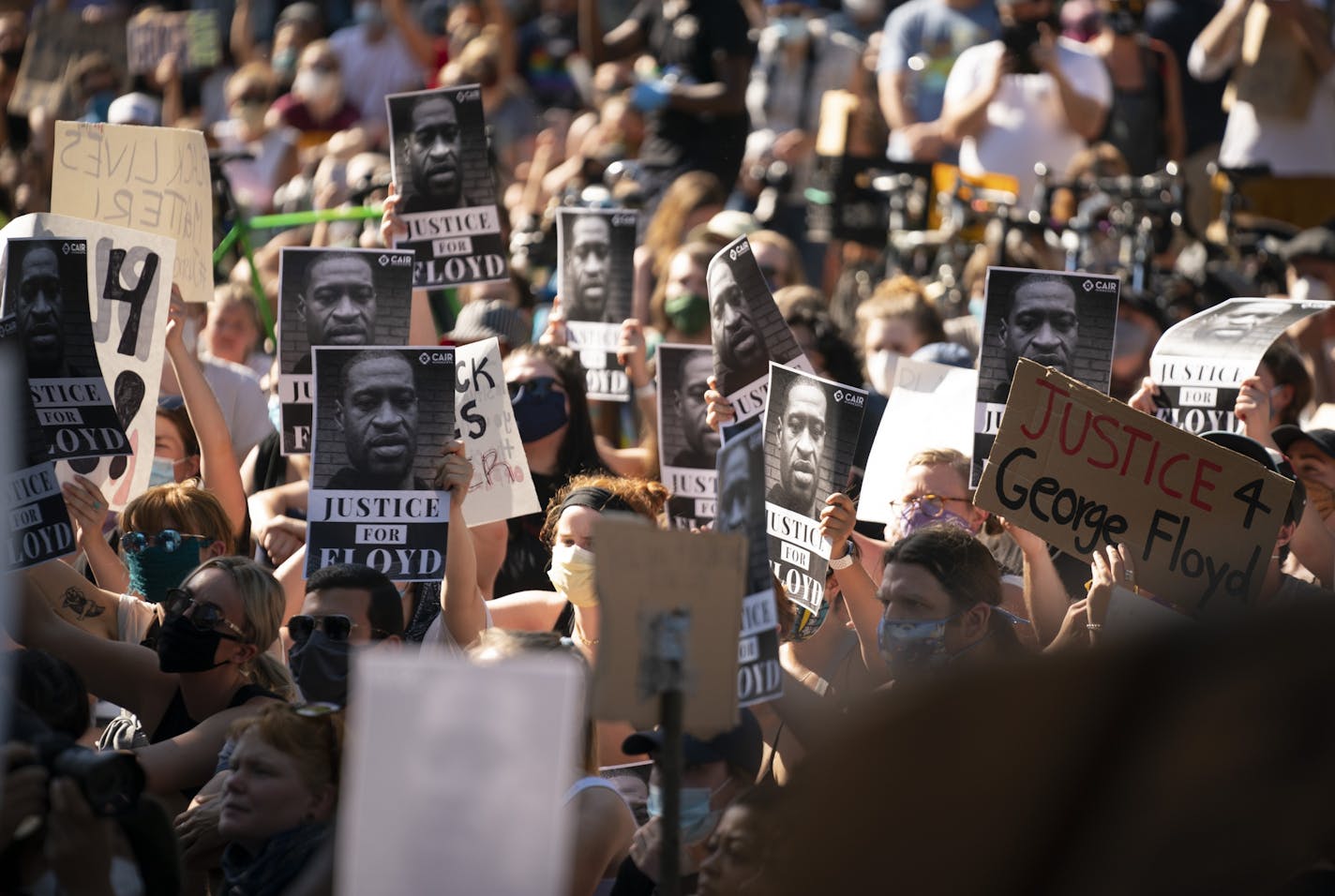 The crowd held posters with the image of George Floyd's face while listening to speakers in front of the governor's residence on Monday, June 1. State health officials will be encouraging protesters to seek COVID-19 testing due to the increased risks of the infectious disease spreading at mass gatherings.