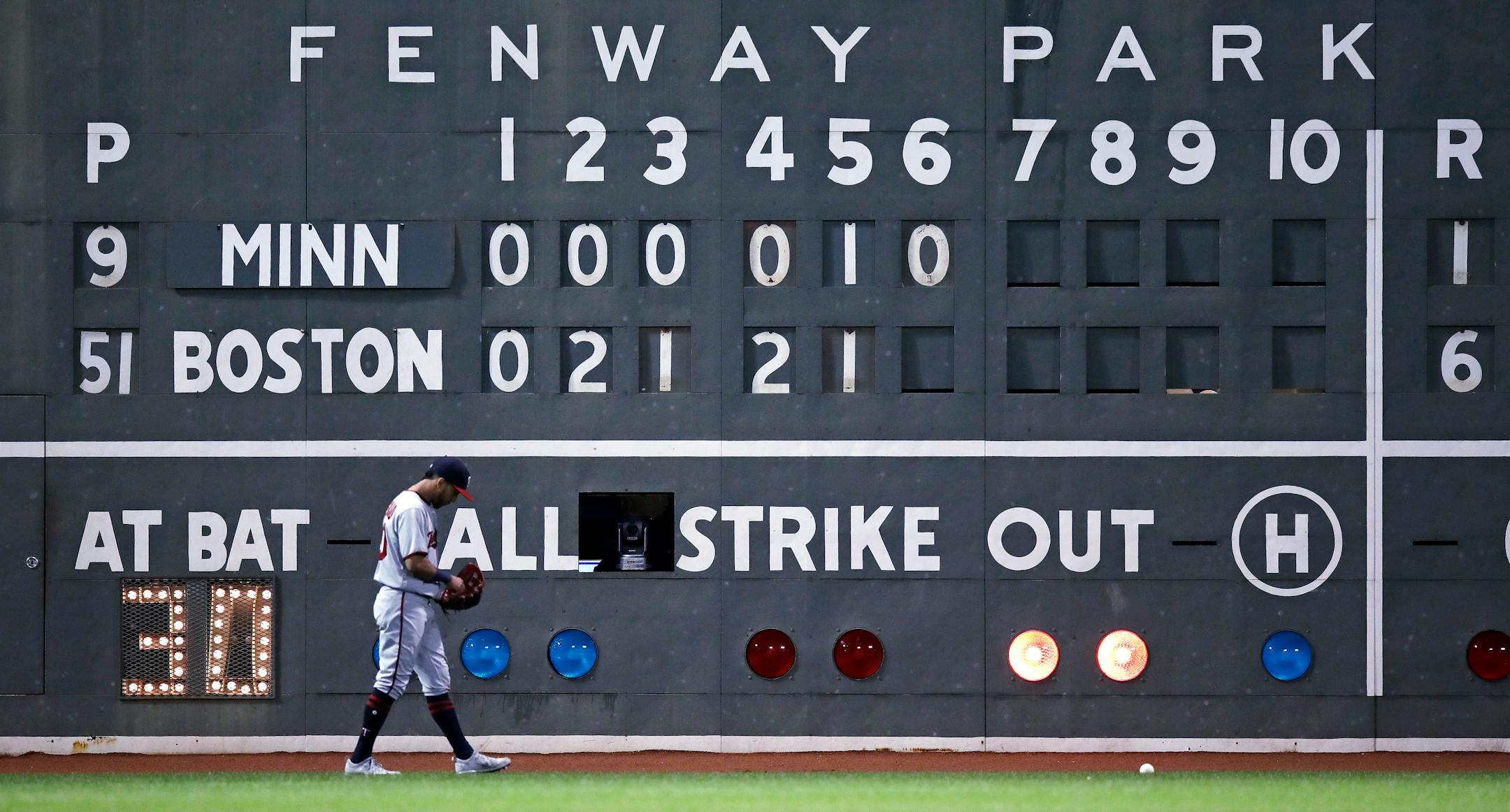 Minnesota Twins left fielder Eddie Rosario walks over to pick up the ball hit by Boston Red Sox's Chris Young that fell out of the stands after a three-run home run during the sixth inning of a baseball game at Fenway Park in Boston, Tuesday, June 27, 2017. (AP Photo/Charles Krupa)