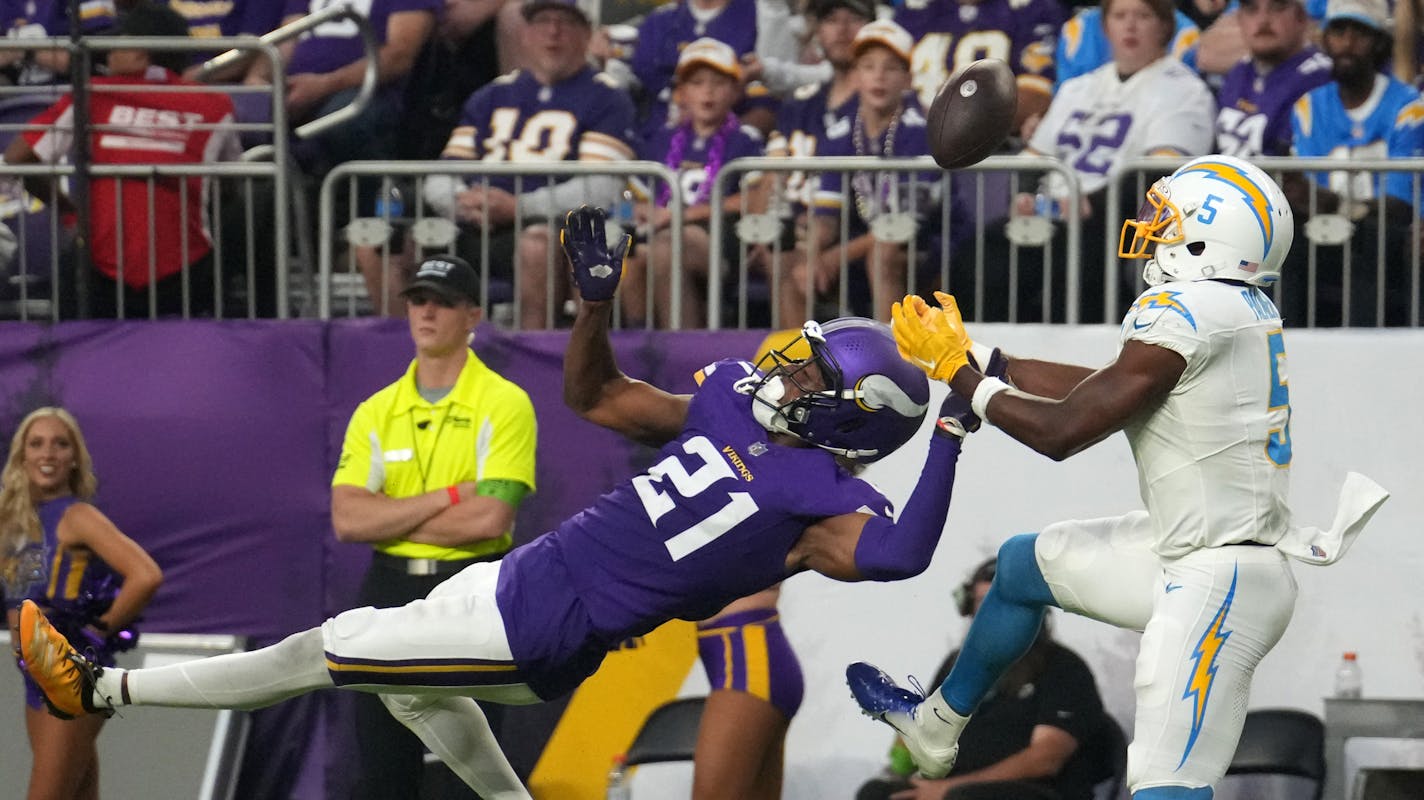 Los Angeles Chargers wide receiver Joshua Palmer (5) catches a touchdown pass off the helmet of Minnesota Vikings cornerback Akayleb Evans (21) in the fourth quarter of an NFL game between the Minnesota Vikings and the Los Angeles Chargers Sunday, Sept. 24, 2023 at U.S. Bank Stadium in Minneapolis. ] ANTHONY SOUFFLE • anthony.souffle@startribune.com