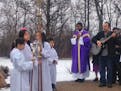 Father Thomas Joseph led more than 100 parishioners out to the prayer garden, stopping near the statue of Our Lady of Guadalupe to sing, during the Su