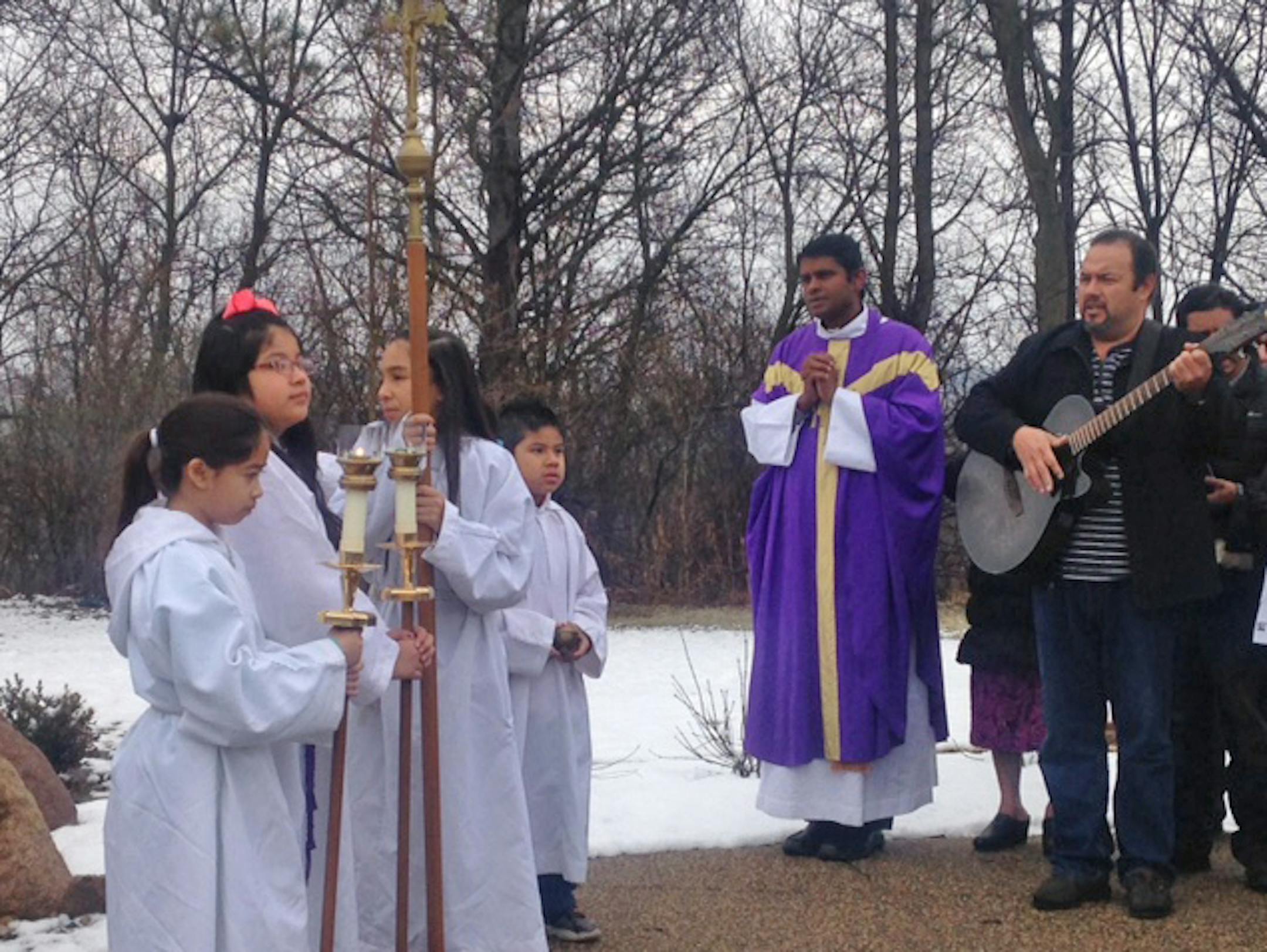 Father Thomas Joseph led more than 100 parishioners out to the prayer garden, stopping near the statue of Our Lady of Guadalupe to sing, during the Sunday mass for Spanish speakers on Dec 4.
Credit: Erin Adler/Star Tribune
