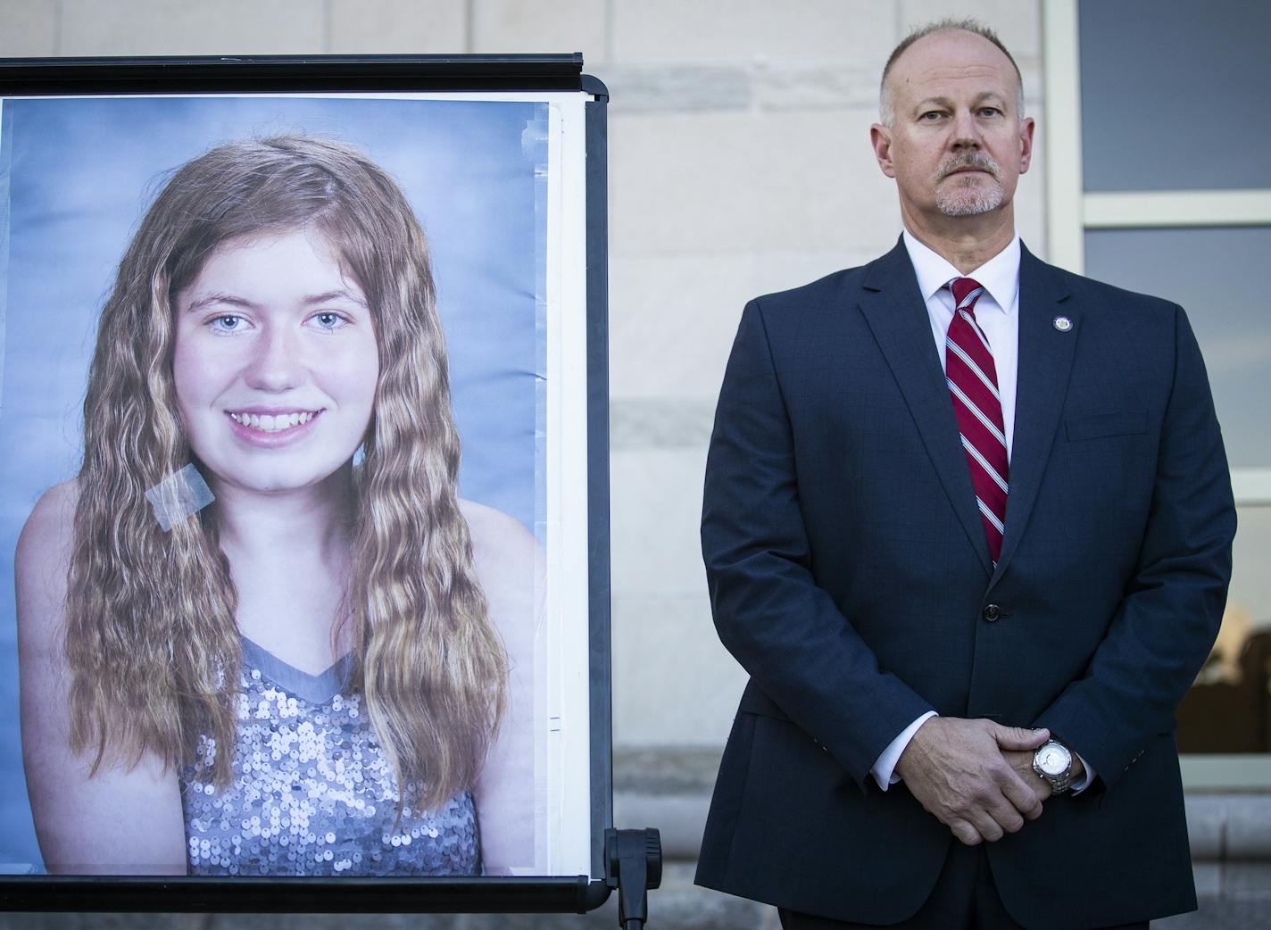 Special agent in charge Chris Deremer with the Wisconsin DCI stands next to a photo of Jayme Closs during a news conference in October.