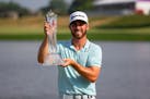 Matthew Wolff poses with the 3M Open trophy after winning the event last July at TPC Twin Cities in Blaine.