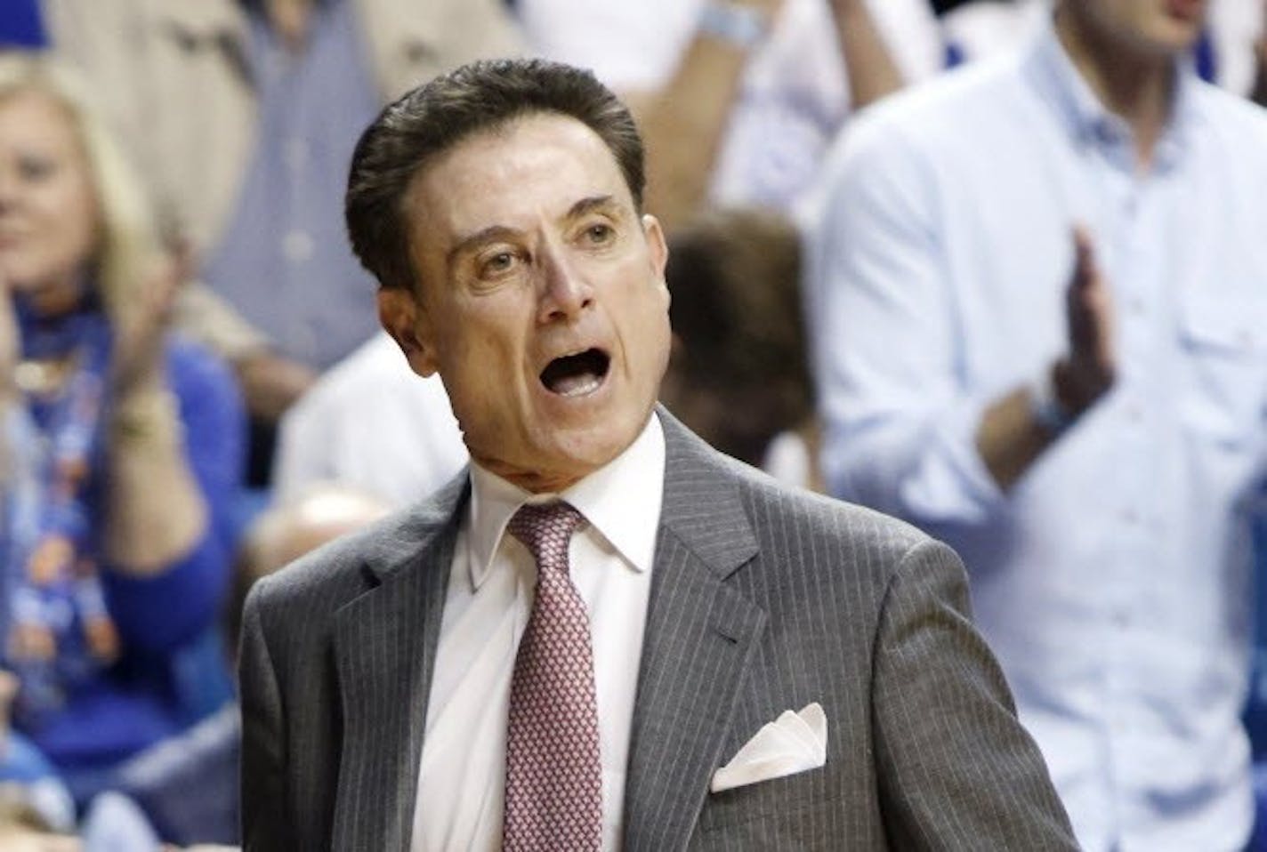 Louisville head coach Rick Pitino urges his team on during the first half of an NCAA college basketball game against Kentucky Saturday, Dec. 26, 2015, in Lexington, Ky.