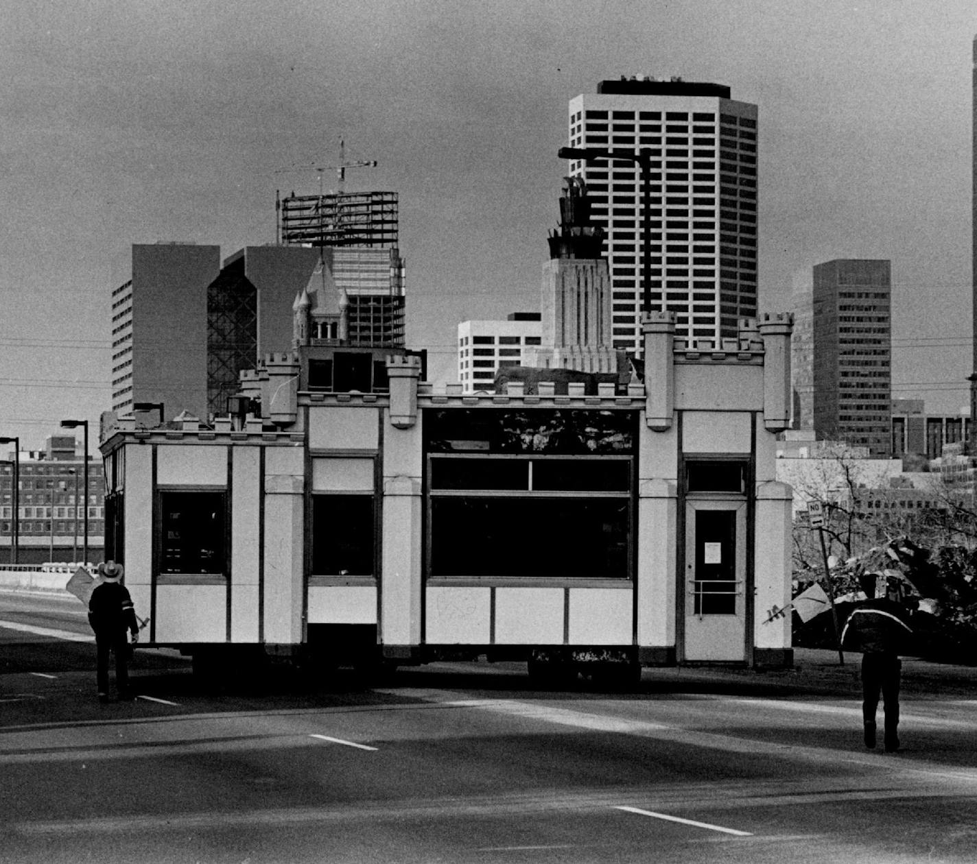 April 2, 1984 Starting across the 3rd Ave. bridge (about 7:15 A.M.) One White Castle to go, please The white Castle building at 4th St. and Central Av. SE. moved across the 3rd Av. Bridge Sunday morning toward south Minneapolis, where it will take up a new occupation. The building, a fixture of the southeast university area since 1936, will house the corporate offices and showroom of Calamity J. Contracting Co., a residential remodeling firm, at 3252 Lyndale Av. S. Kristin Wilson, the firm&#xd5;