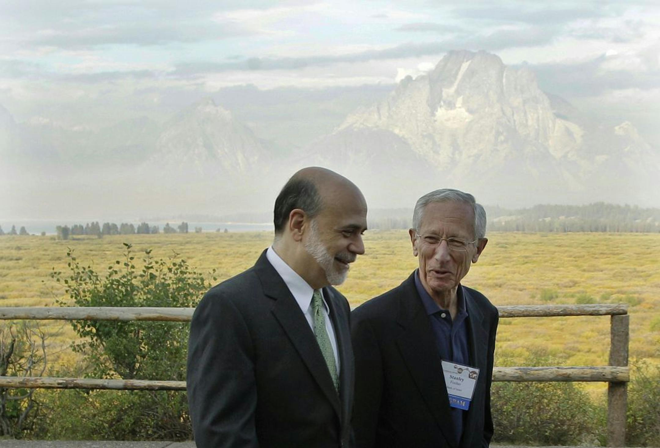 With the Teton Mountains behind them, Federal Reserve Chairman Ben Bernanke, left, and Bank of Israel Governor Stanley Fischer walk together outside of the Jackson Hole Economic Symposium, Friday, Aug. 31, 2012, at Grand Teton National Park near Jackson Hole, Wyo. Bernanke made clear Friday that the Federal Reserve will do more to boost the economy because of high U.S. unemployment and an economic recovery that remains "far from satisfactory."