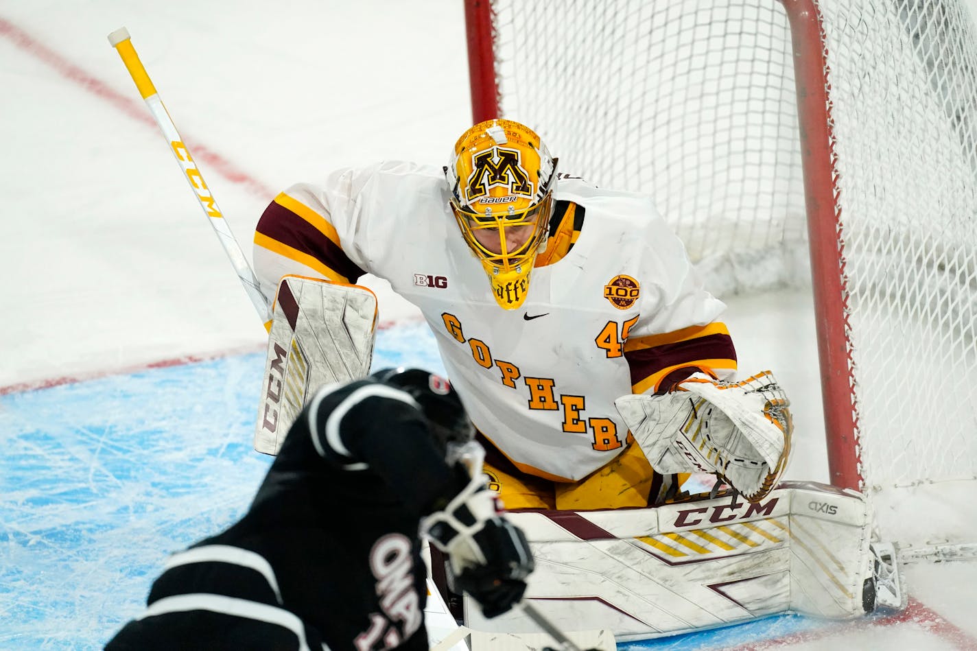 Minnesota goaltender Jack LaFontaine stops a shot off the stick of Omaha forward Taylor Ward during the second period of an NCAA West Regional college hockey semifinal Saturday, March 27, 2021, in Loveland, Colo. (AP Photo/David Zalubowski)