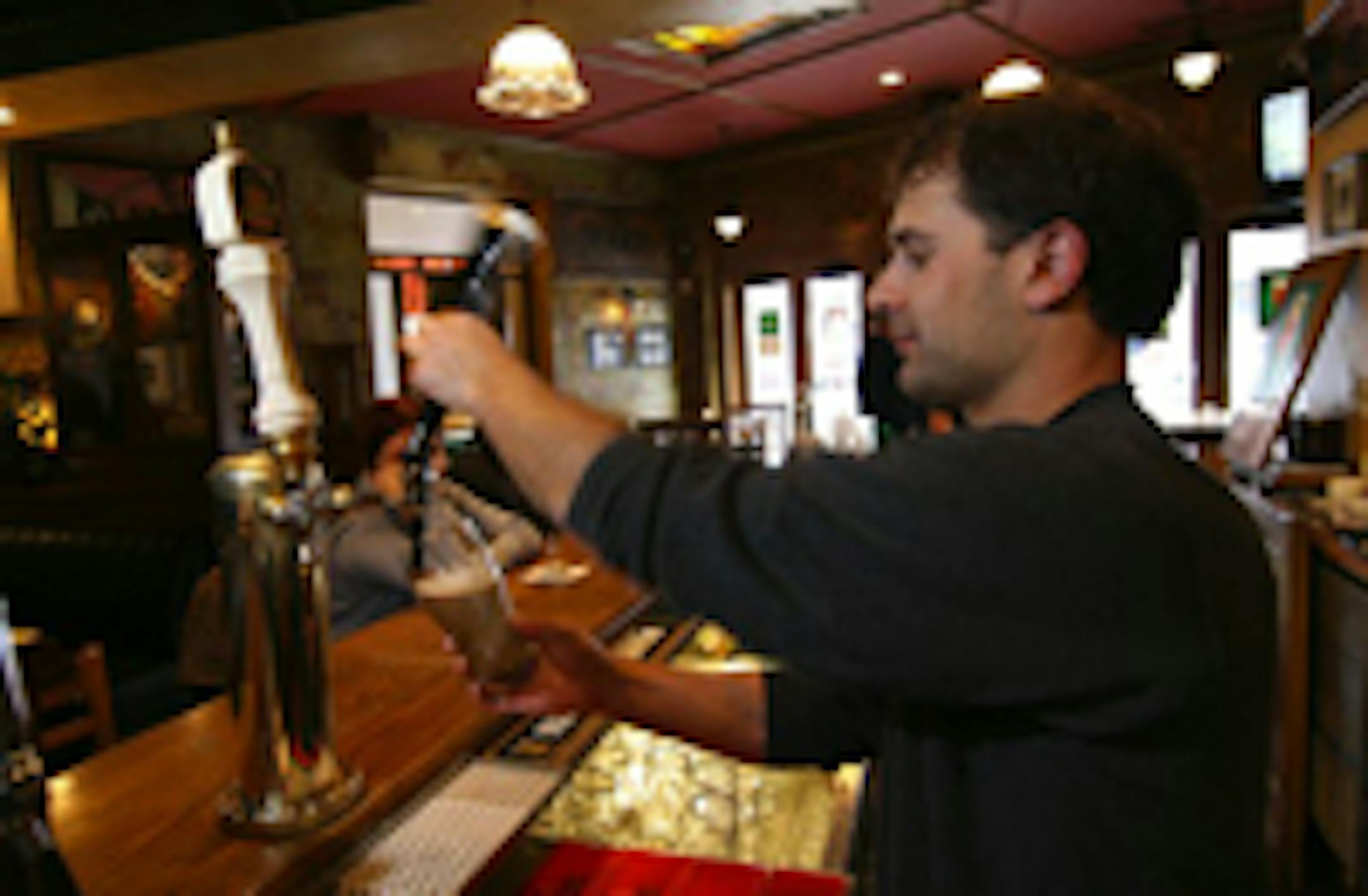 Bartender Grant Fobel pours a drink at O'Donovan's.
