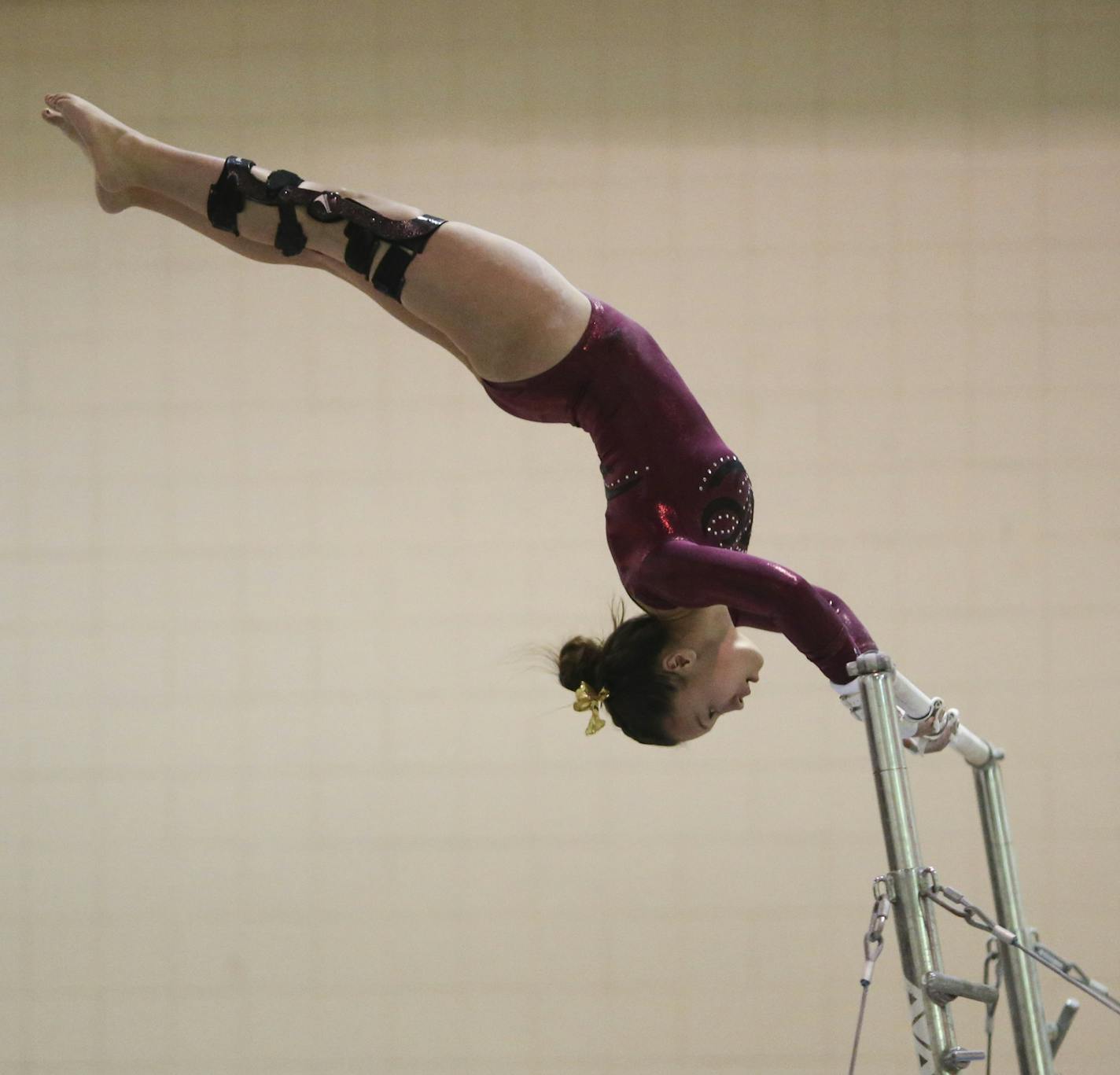 Sophia Thompson set up her dismount while performing her routine on the uneven bars Tuesday night. ] JEFF WHEELER &#xef; jeff.wheeler@startribune.com Maple Grove senior gymnast Sophia Thompson reluctantly moved with her family to Maple Grove from North Dakota. After major surgery on both knees she has come out of retirement to finish her career with Maple Grove. She competed on the uneven bars in a meet against Coon Rapids Tuesday night, December 1, 2015 at Maple Grove.