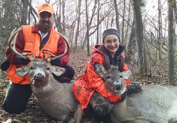 Jason Pommier, and daughter, Heather, 10, of North Branch, with deer they bagged Sunday. It was Heather's first whitetail.