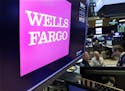 The Wells Fargo logo appears above a trading post on the floor of the New York Stock Exchange, Wednesday, Feb. 7, 2018. (AP Photo/Richard Drew)