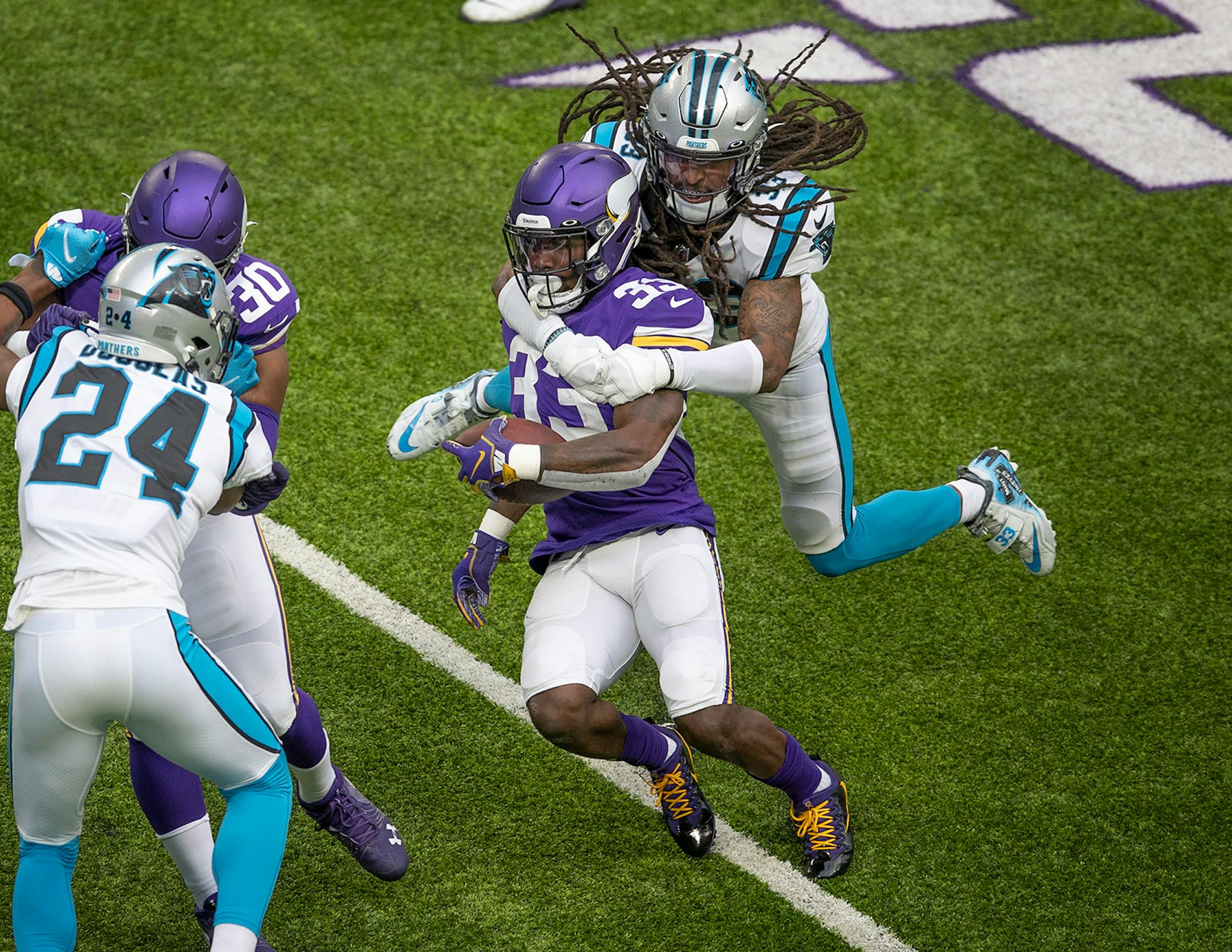 Carolina Panthers free safety Tre Boston (33) tackled Minnesota Vikings running back Dalvin Cook (33) after he picked up two yards in the first quarter.