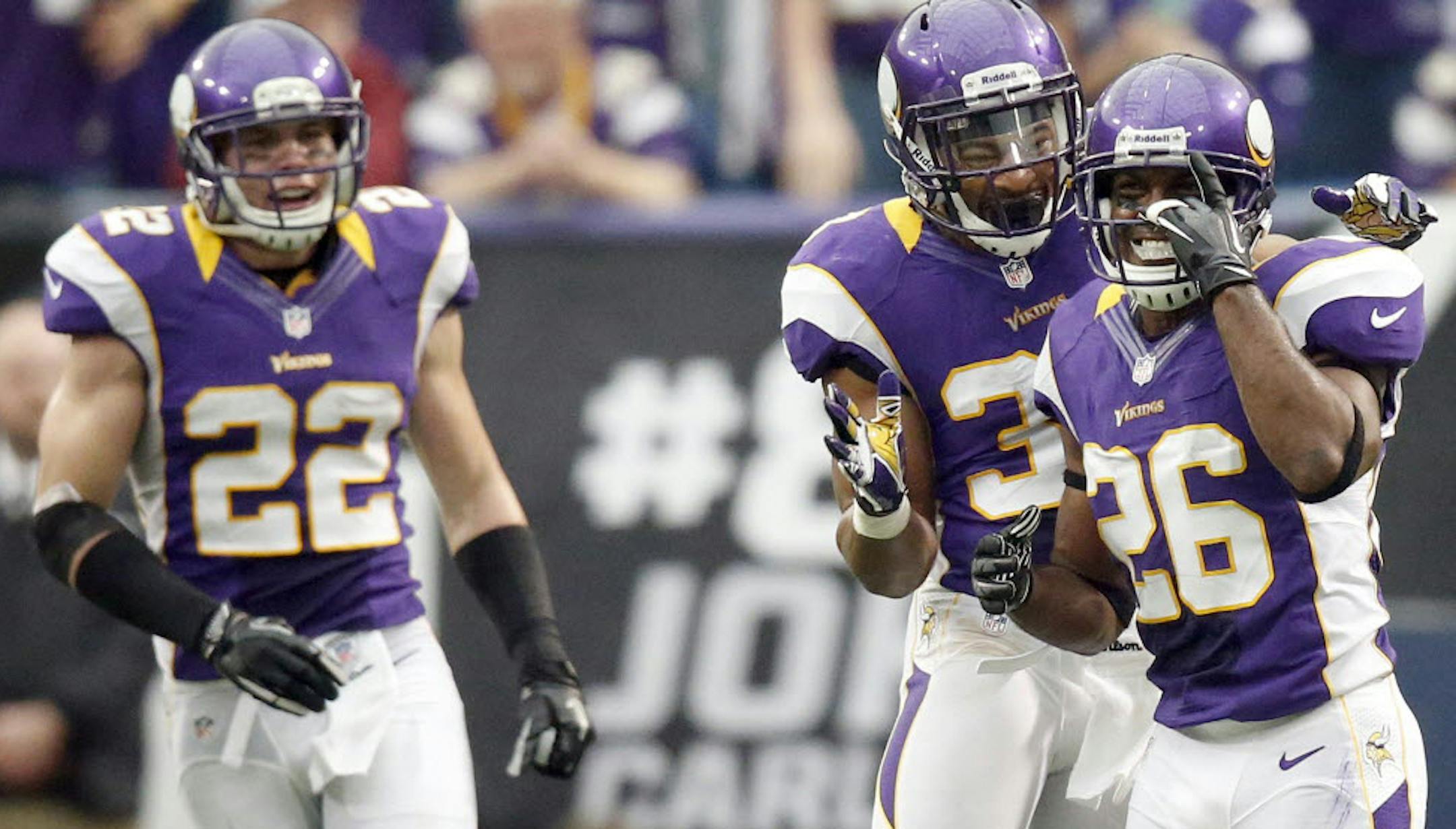 Minnesota Vikings Antoine Winfield (26) celebrated with Jamarca Sanford (33) after he stopped Cardinals quarterback John Skelton (19) on a fourth down in the third quarter.
