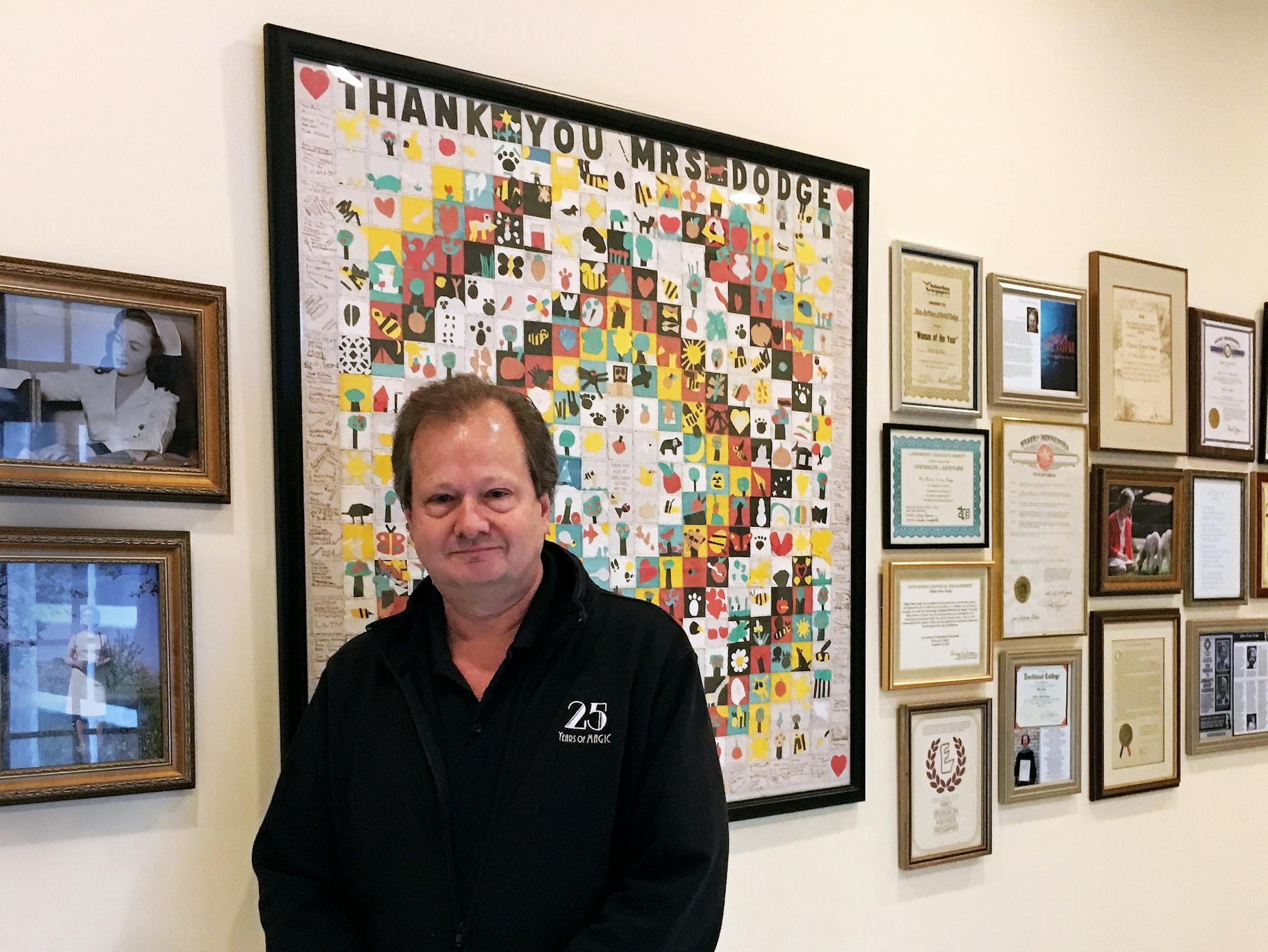 Tom Dodge spearheaded the creation of the Olivia Irvine Dodge Library and History Center at Dodge Nature Center in West St. Paul. The center honors his mother, Olivia Irvine Dodge. Here, he stands by pictures of his mother.