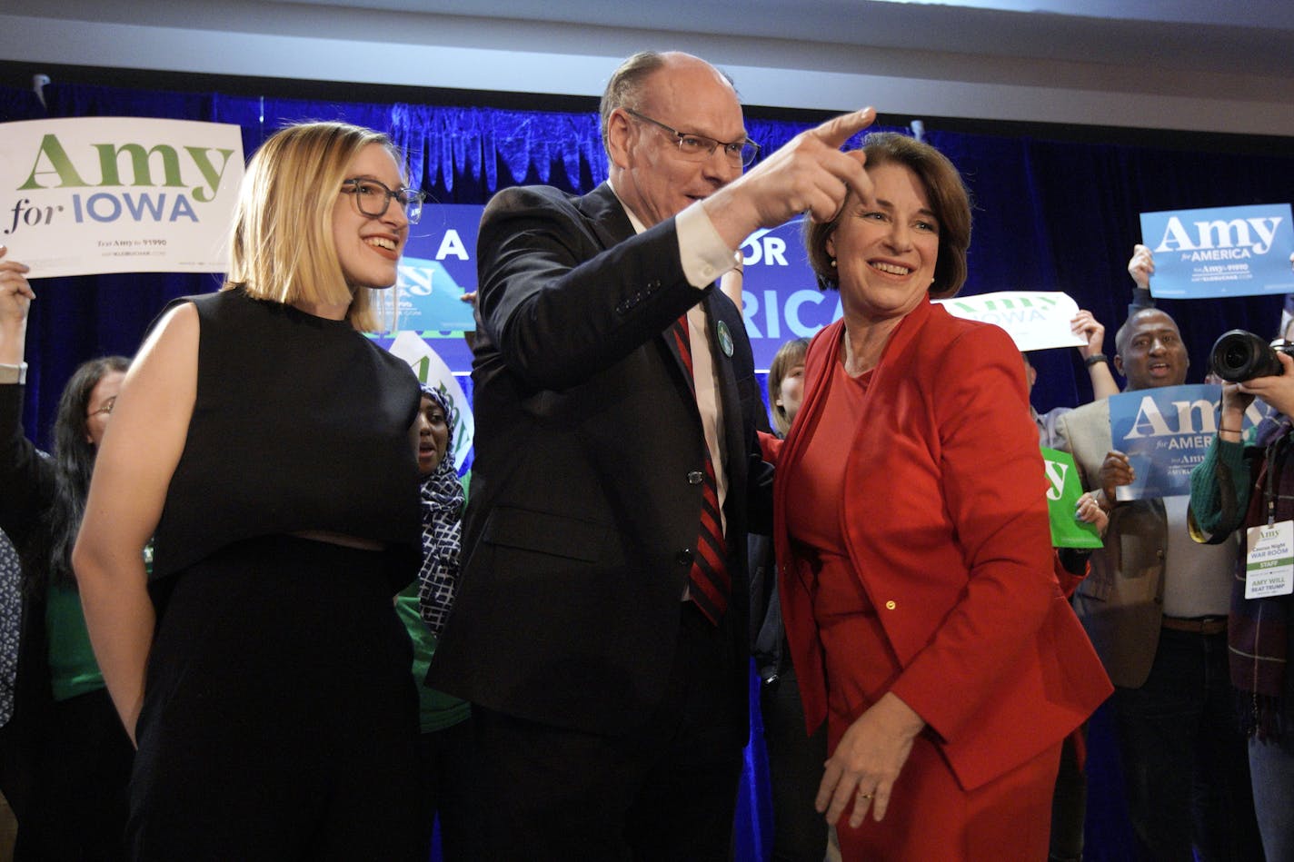 Sen. Amy Klobuchar stands with her husband, John Bessler, and daughter Abigail Klobuchar Bessler, left, after speaking to supporters at her caucus night campaign rally in Des Moines, Iowa, on Feb. 3.