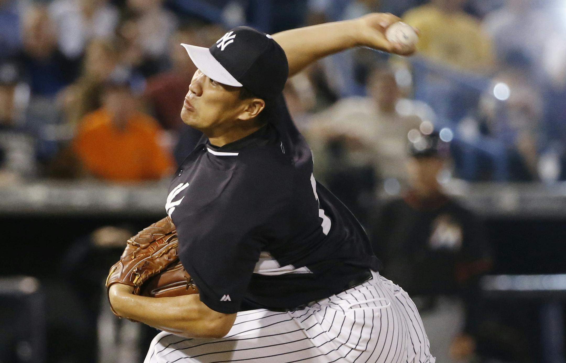 A flash goes off as New York Yankees relief pitcher Masahiro Tanaka delivers a seventh-inning pitch in a spring exhibition baseball game against the Miami Marlins in Tampa, Fla., Friday, March 28, 2014. The Yankees won 3-0. (AP Photo/Kathy Willens)