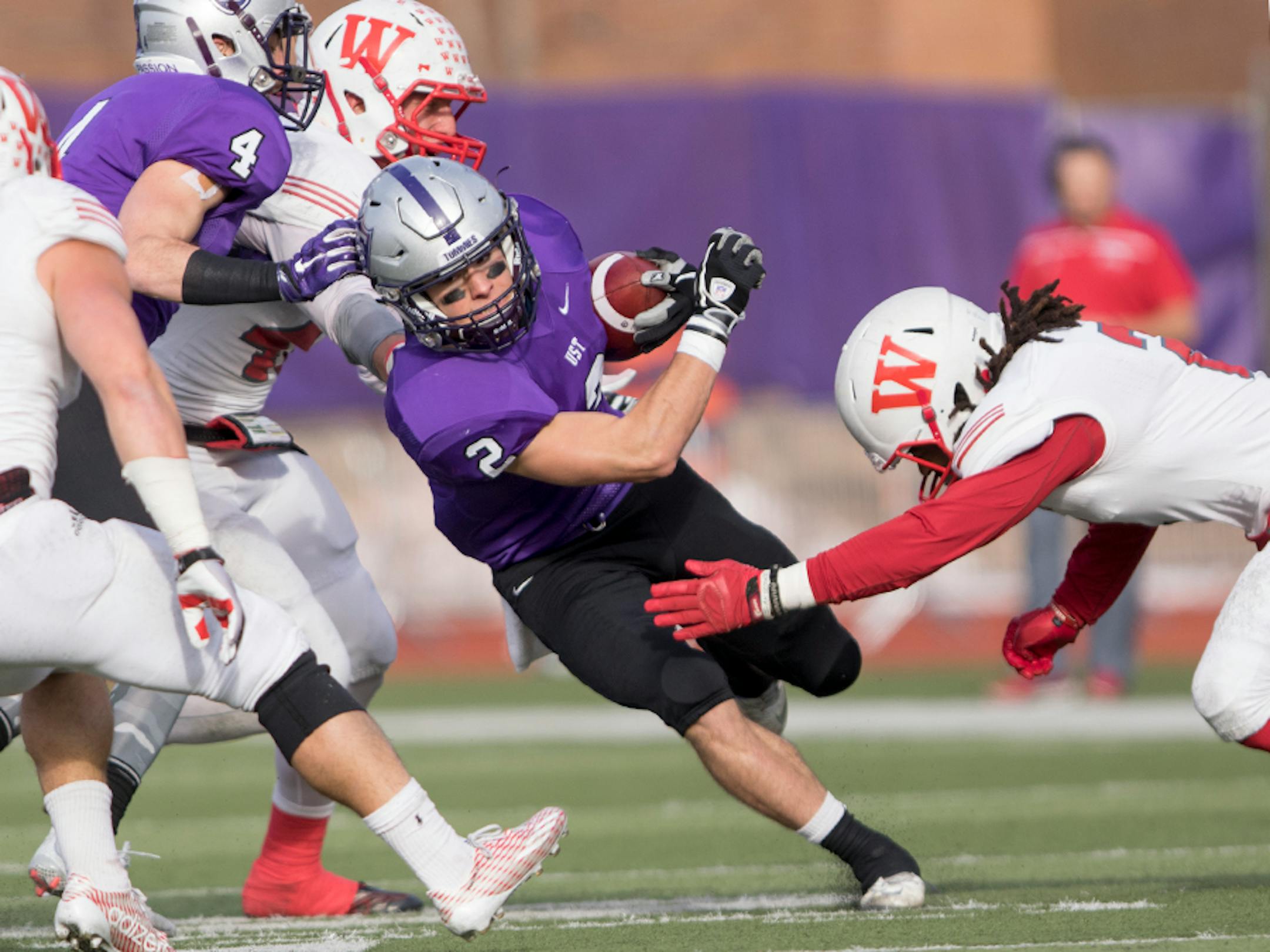 St. Thomas receiver Nick Waldvogel (2) splits the defenders as the University of St. Thomas Tommies hosted the Wabash College Little Giants on December 5, 2015.