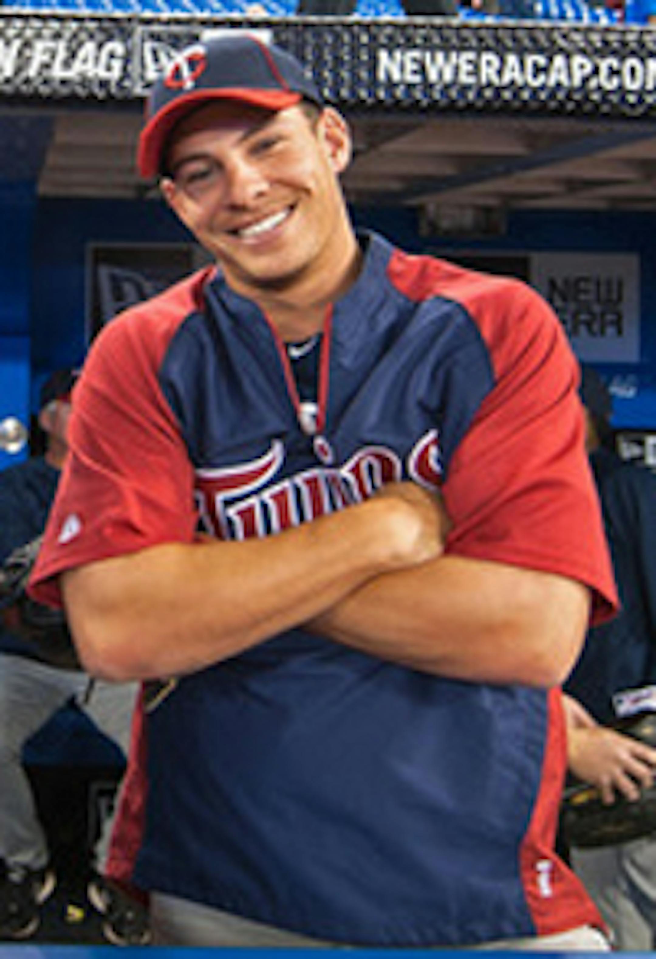 TORONTO,CANADA - APRIL 1:  Matt Tolbert #20 and Danny Valencia #19 of the Minnesota Twins pose for a photo prior to the home opener for the Toronto Blue Jays as they face the Minnesota Twins during their MLB game at the Rogers Centre April 1, 2011 in Toronto, Ontario, Canada.(Photo By Dave Sandford/Getty Images)