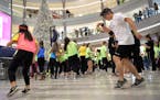 Alex Johnson, 23, of Rochester get down to tunes blasting in the Mall of America's Rotunda for the first ever Unified Dance Marathon to Benefit Specia