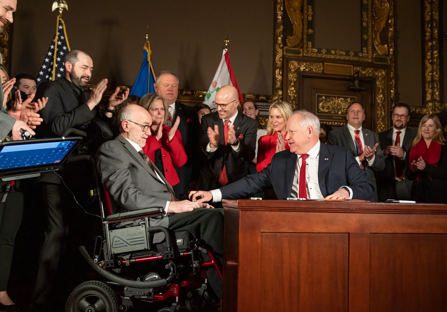 Gov. Tim Walz handed the first signing pen to Sen. David Tomassoni, DFL-Chisholm, after he signed the ALS bill into law, Wednesday, March 30, 2022, St. Paul, Minn. ] GLEN STUBBE • glen.stubbe@startribune.com