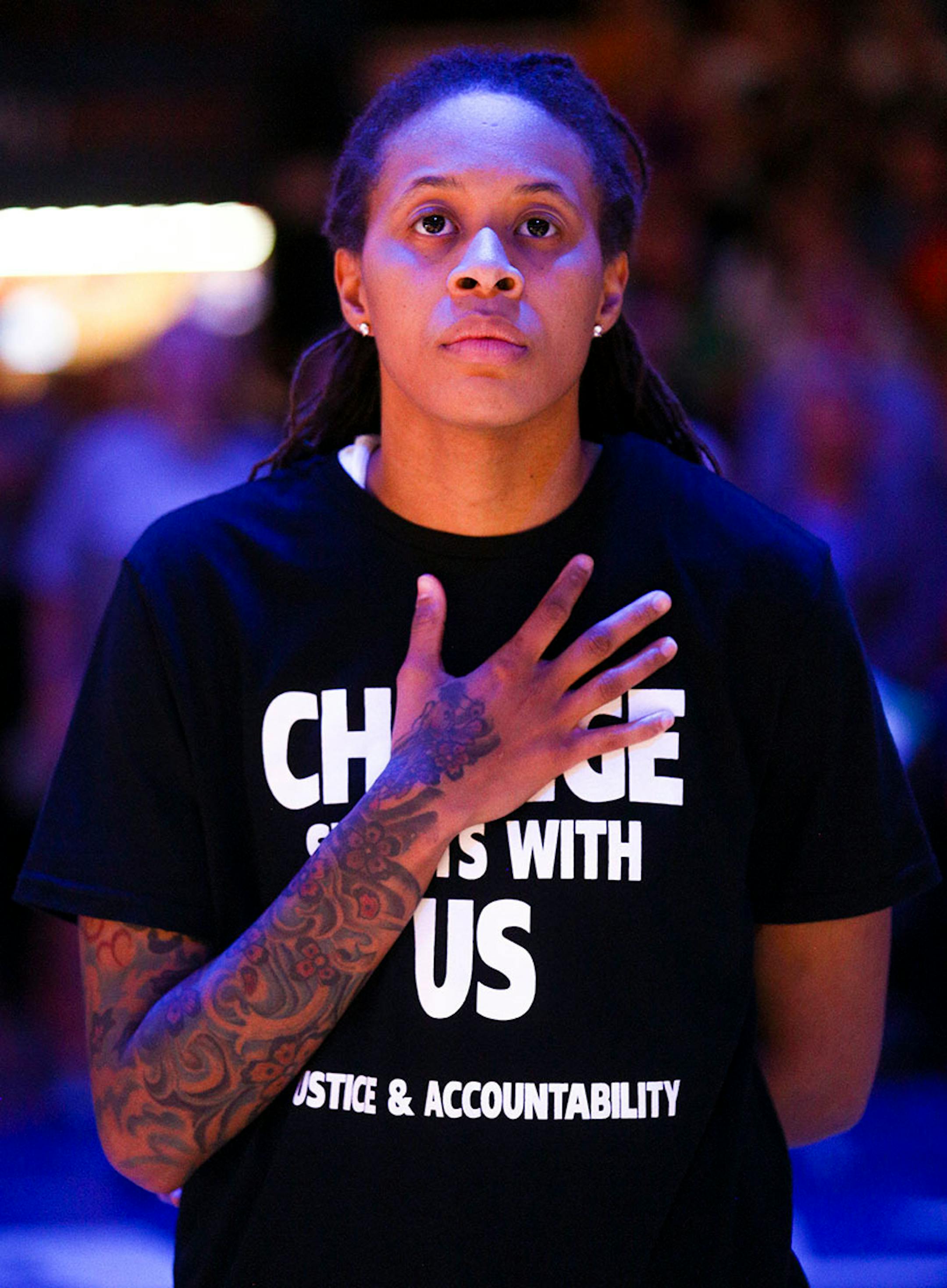 Minnesota Lynx guard Seimone Augustus (33) places her hand over her heart during the playing of the national anthem.