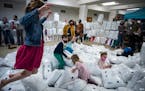 Children at Lake Harriet United Methodist Church in Minneapolis played in a pile of (plastic-wrapped) pillows, which will be donated to local homeless