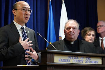 Ramsey County District Attorney Jon Choi stood with Archbishop Bernard Hebda during a press conference after submitting their final progress report on