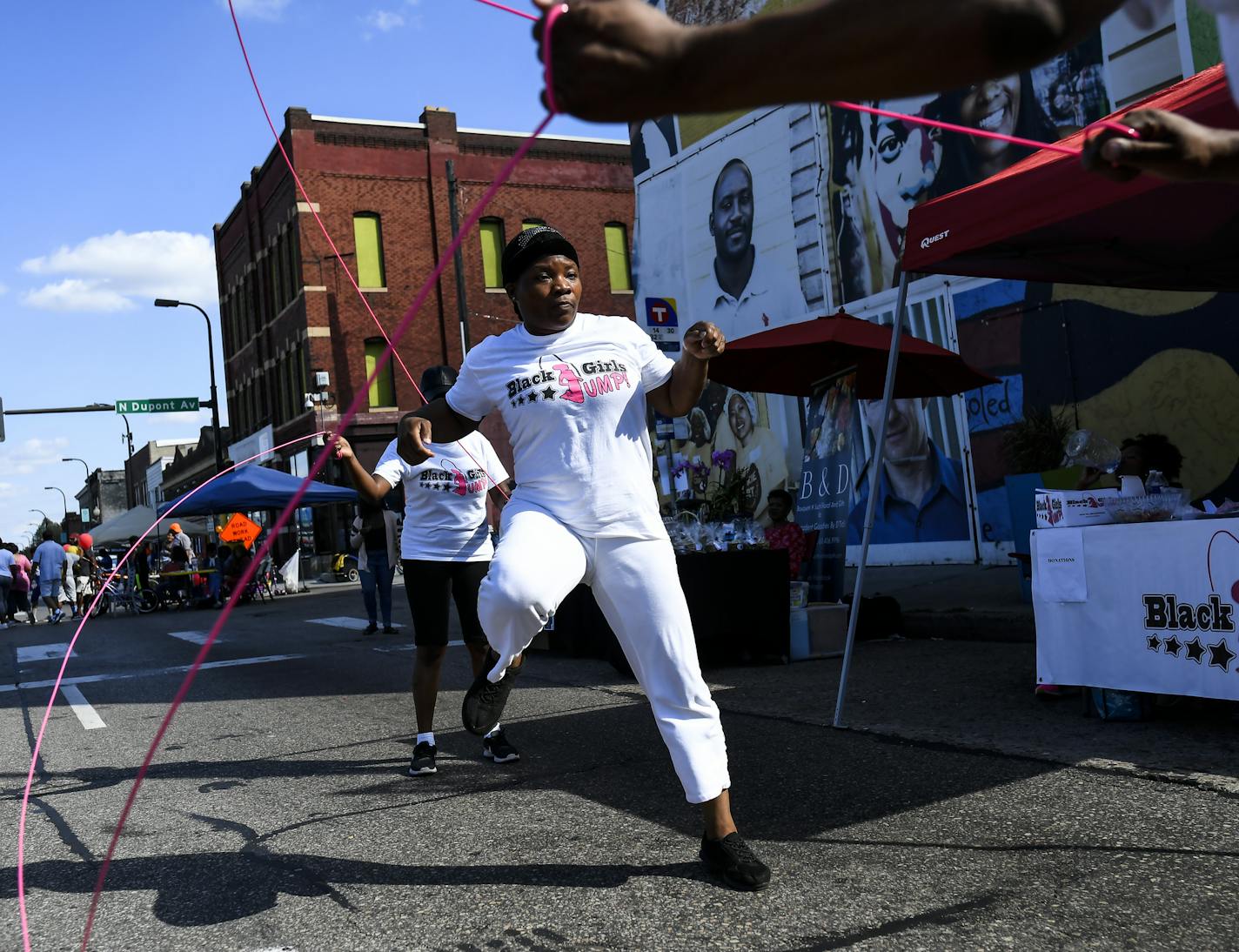 Danielle Burns, with "Black Girls Jump," jumped rope Saturday during Open Streets West Broadway. ] AARON LAVINSKY &#xa5; aaron.lavinsky@startribune.com A look at West Broadway and how it has changed due to a grassroots movement and city investments. We photograph Open Streets West Broadway on Saturday, Sept. 15, 2018 in Minneapolis, Minn.