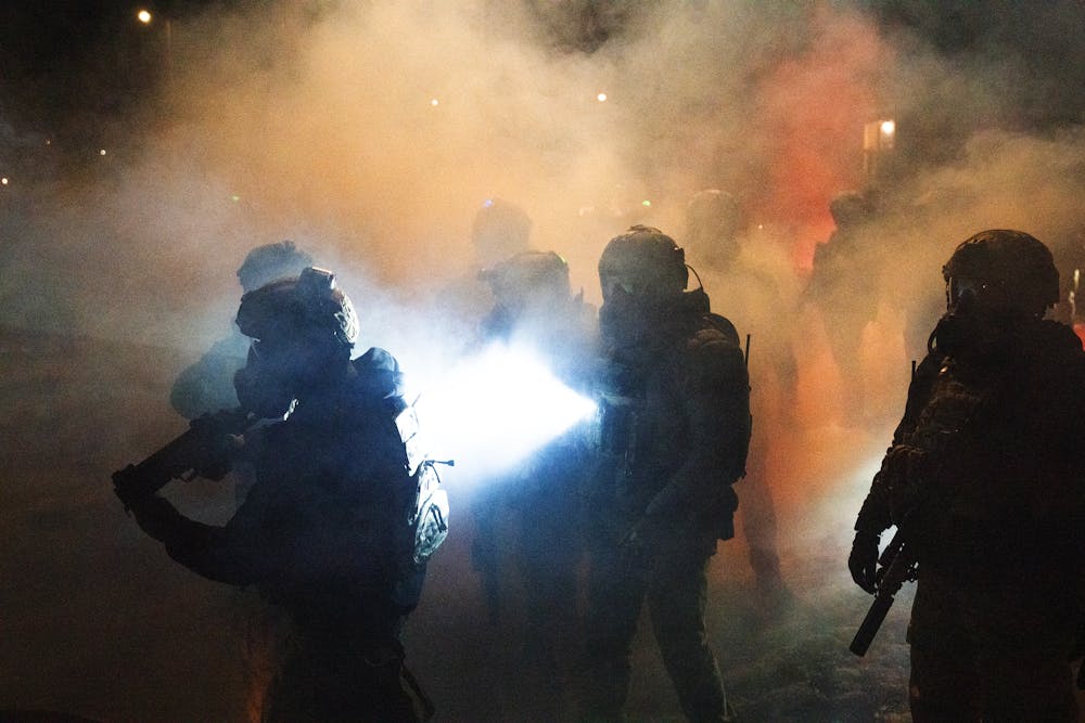 Federal agents deploy chemical irritants as they try to push demonstrators farther from the scene where a federal agent shot a man in north Minneapolis on Wednesday, Jan. 14.