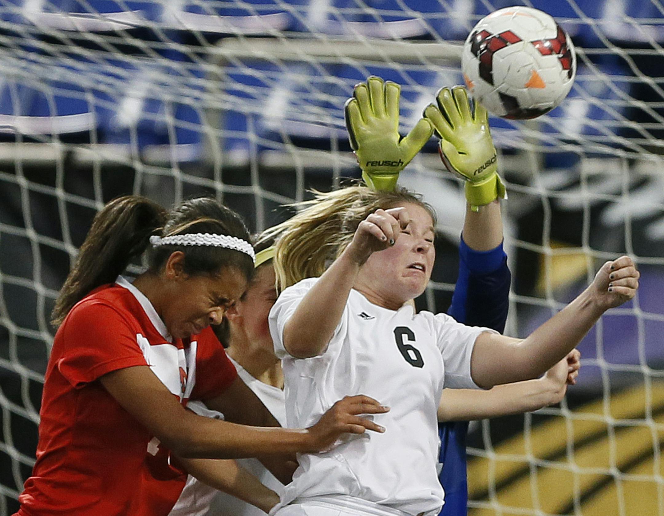 Lakeville North's Olivia Bruce try to score on a corner kick as Burnsville's Abby Soderholm protected the net during class 2A girls soccer action at the metro dome between Lakeville North and Burnsville Tuesday October 29, 2013 in Minneapolis, MN. Lakeville North beat Burnsville 1-0.] JERRY HOLT ‚Ä¢ jerry.holt@startribune.com