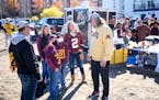 Jerry Kieft greeted quarterback Tanner Morgan’s mother, Pat (No. 2 jersey), and family friends Jaxon and Jace Trettin before the Oct. 23 game agains