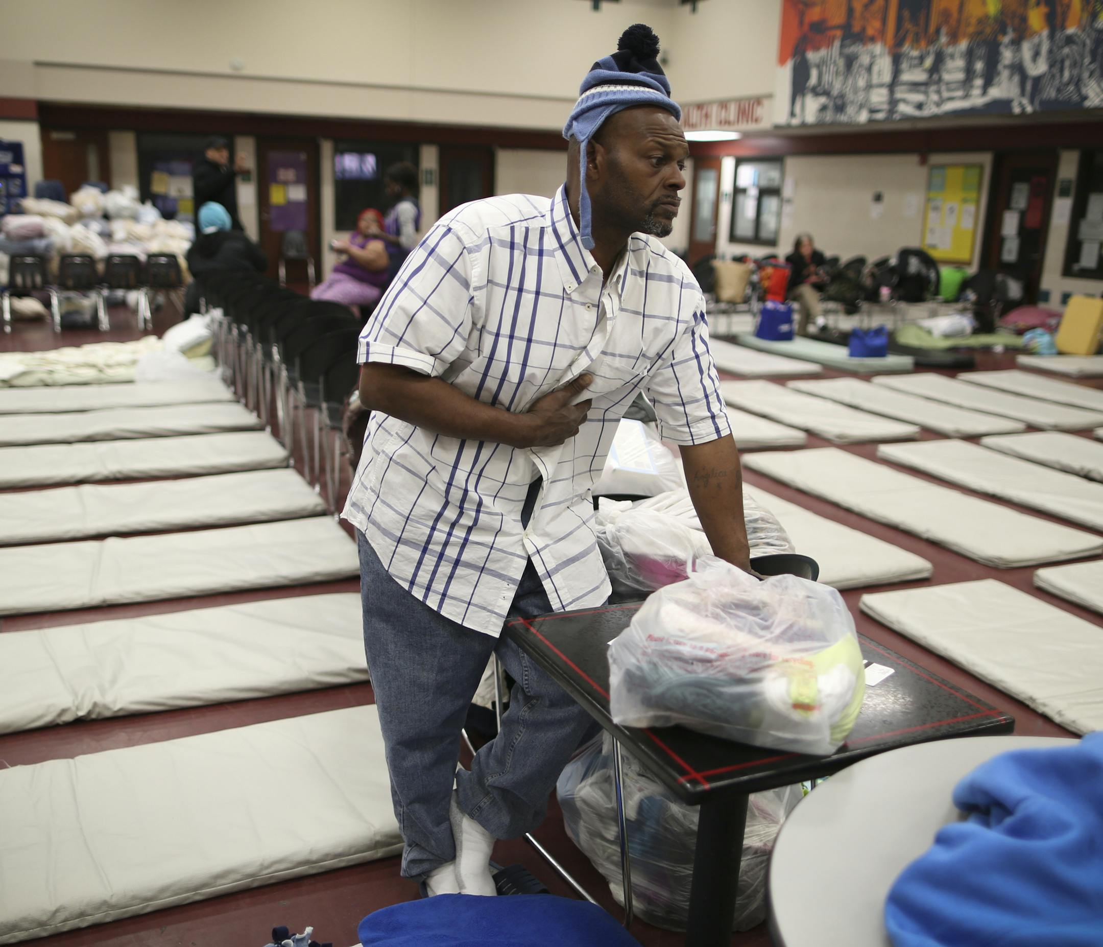 George Smith paused as he talked about his housing situation at the Dorothy Day Center in St. Paul, Minn. on Thursday, May 2, 2013. Smith and his wife lost their housing a month ago after health problems and are staying at the center temporarily. They sleep as close as they can together, on the border of tables and chairs that separates the men and women in one of the rooms at the center. ] (RENEE JONES SCHNEIDER * reneejones@startribune.com)