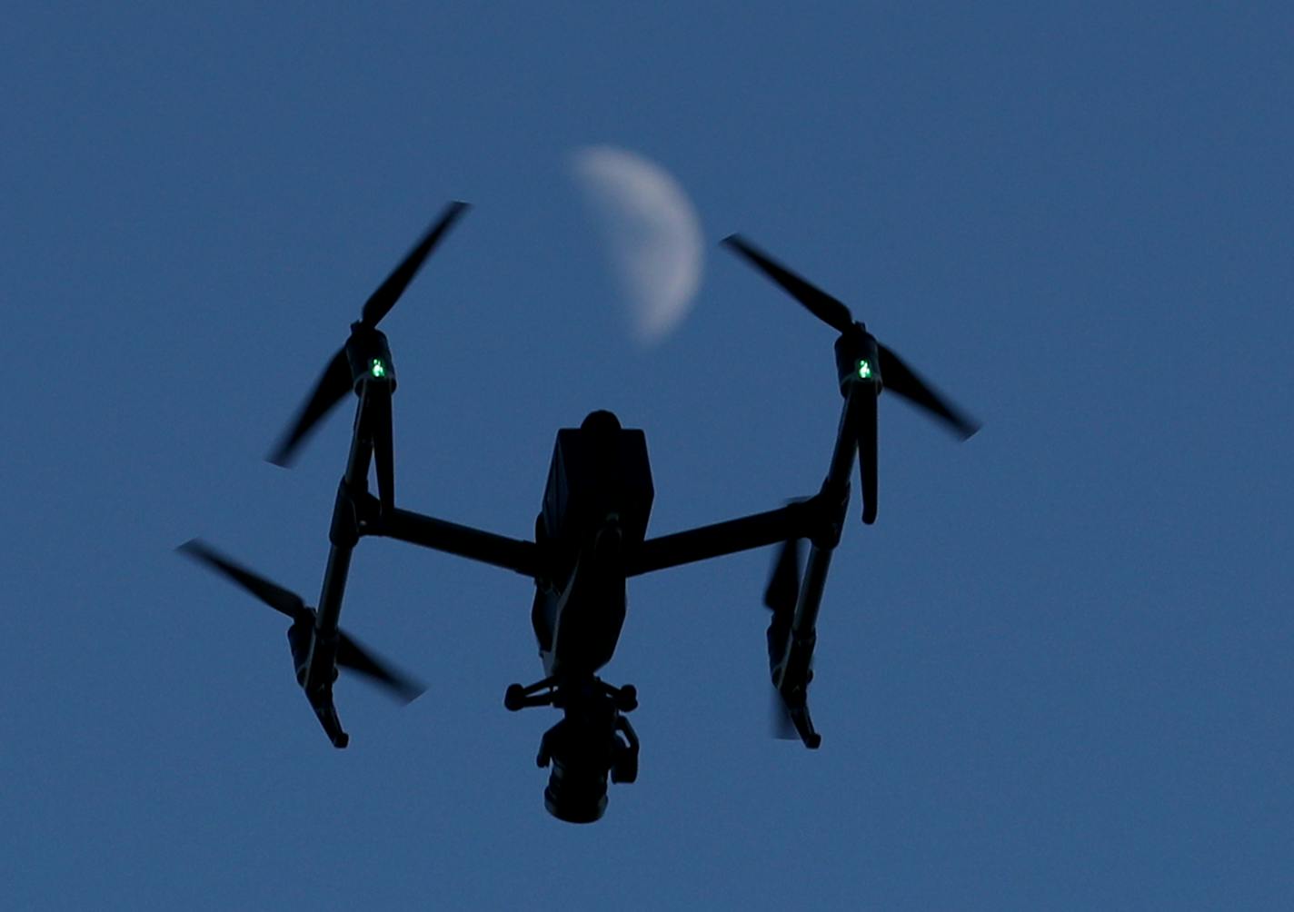 The official event drone flies above the course and below a half moon at the Red Bull Crashed Ice 2017: Saint Paul Friday, Feb. 3, 2017, in St. Paul, MN.] DAVID JOLES &#xef; david.joles@startribune.com Red Bull Crashed Ice 2017: Saint Paul