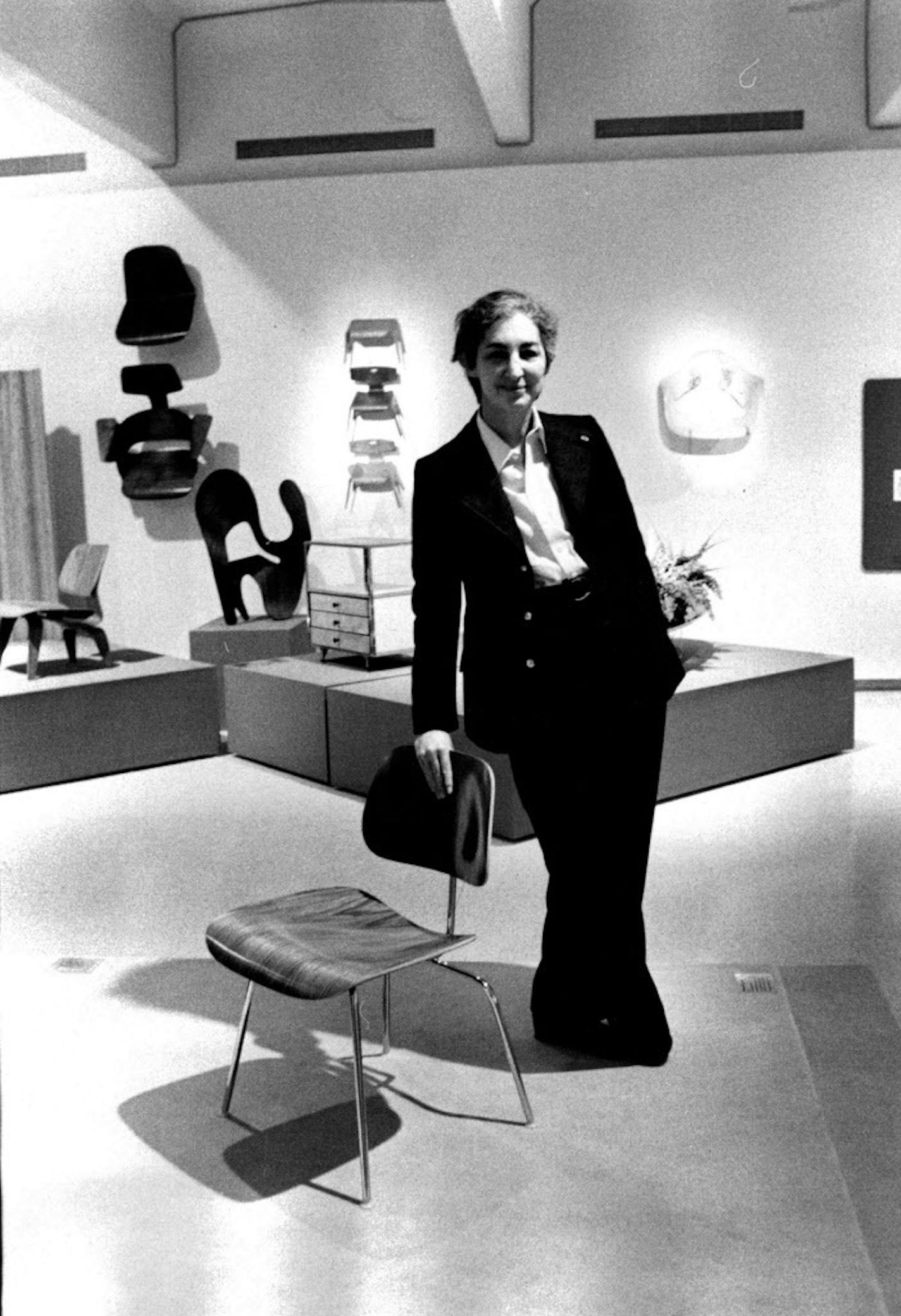 Mildred Friedman posed with an Eames chair at the Walker in 1975.