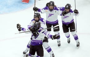 Frost forward Britta Curl-Salemme (77) celebrates her game-winning goal against the Charge in Ottawa on Thursday night.