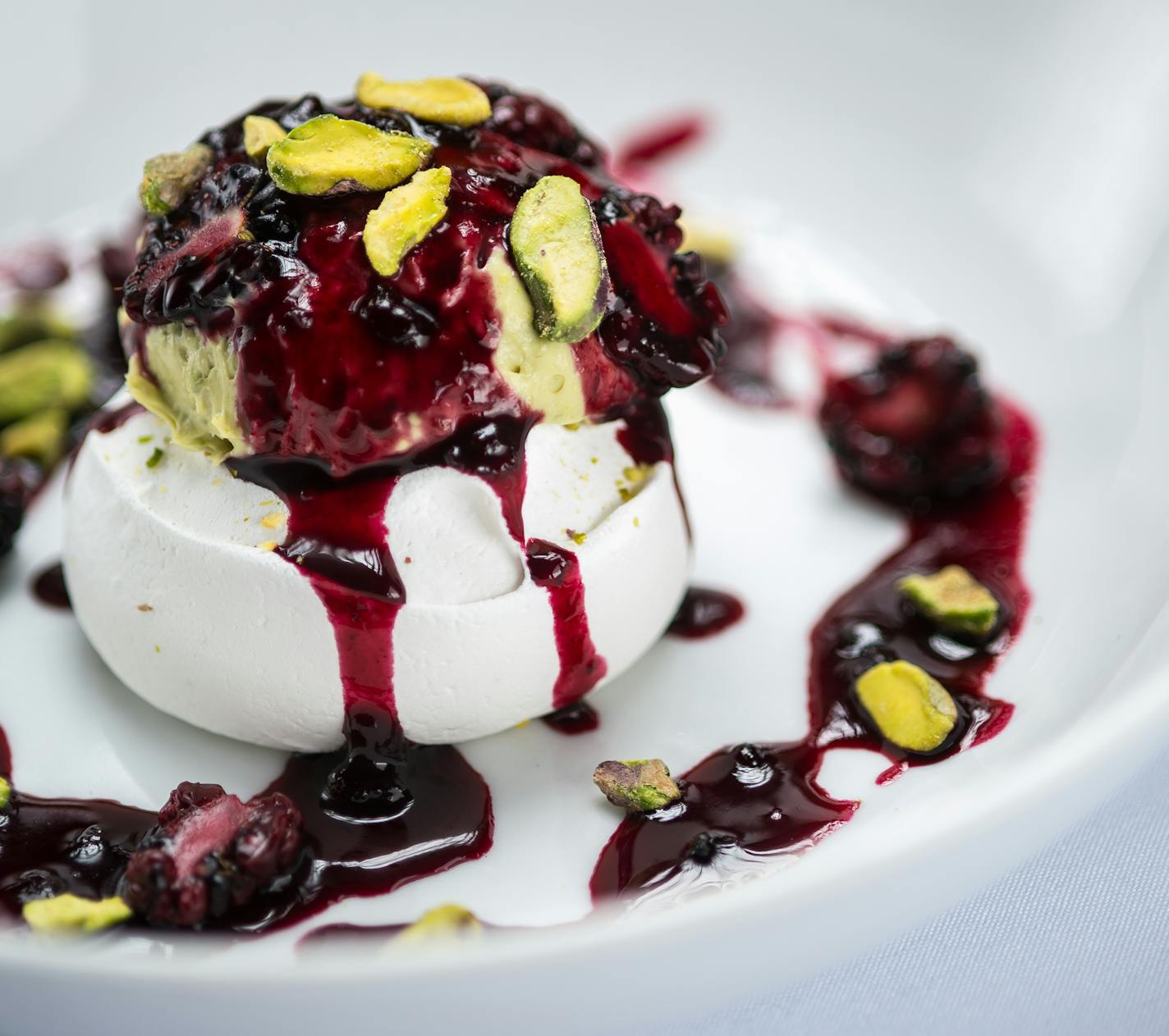 Pistachio Pavlova with blackberry black currant compote.