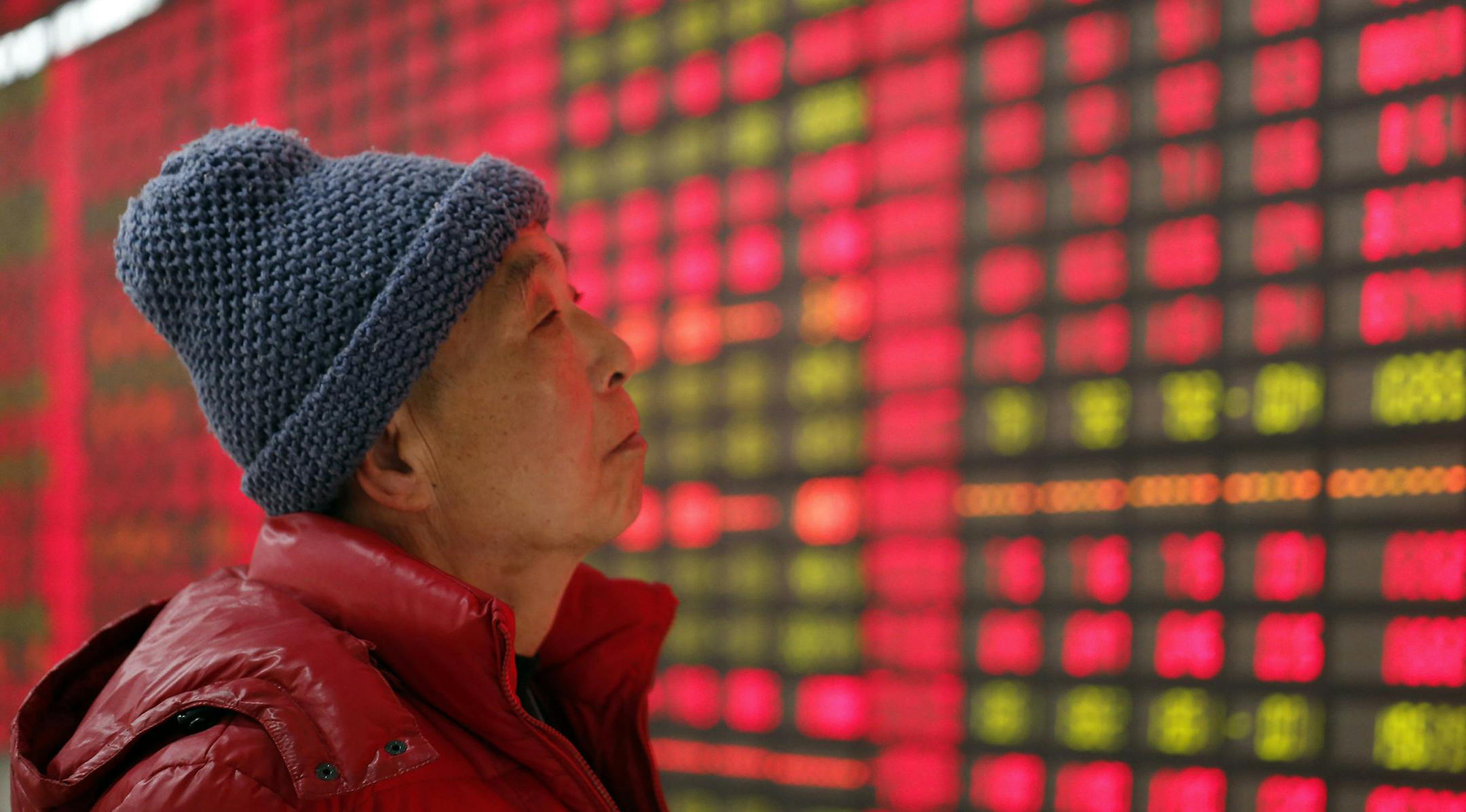 An investor looks at the stock price monitor at a securities company on Dec. 24, 2013 in Shanghai, China.
