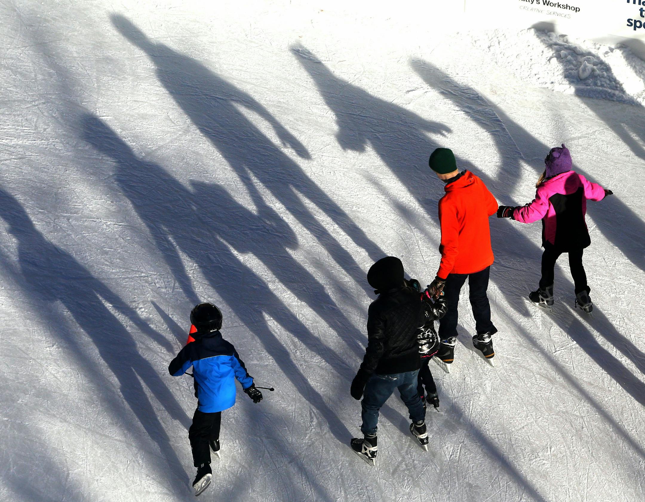The Wells Fargo WinterSkate rink was a busy one at Rice Park Saturday, Nov 28, 2015. Seen from the Ladmark Center, skaters cast long shadows as the afternoon sun shines bright.](DAVID JOLES/STARTRIBUNE)djoles@startribune.com The Wells Fargo Winter Skate rink at Rice Park ORG XMIT: MIN1511281600451301