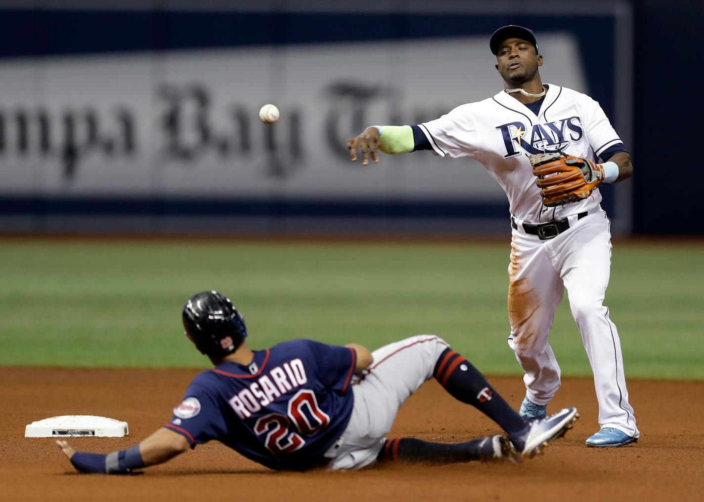 Tampa Bay Rays shortstop Adeiny Hechavarria, right, throws to first after forcing out Minnesota Twins' Eddie Rosario at second base and turns a double play on Max Kepler during the sixth inning of a baseball game Tuesday, Sept. 5, 2017, in St. Petersburg, Fla. (AP Photo/Chris O'Meara)