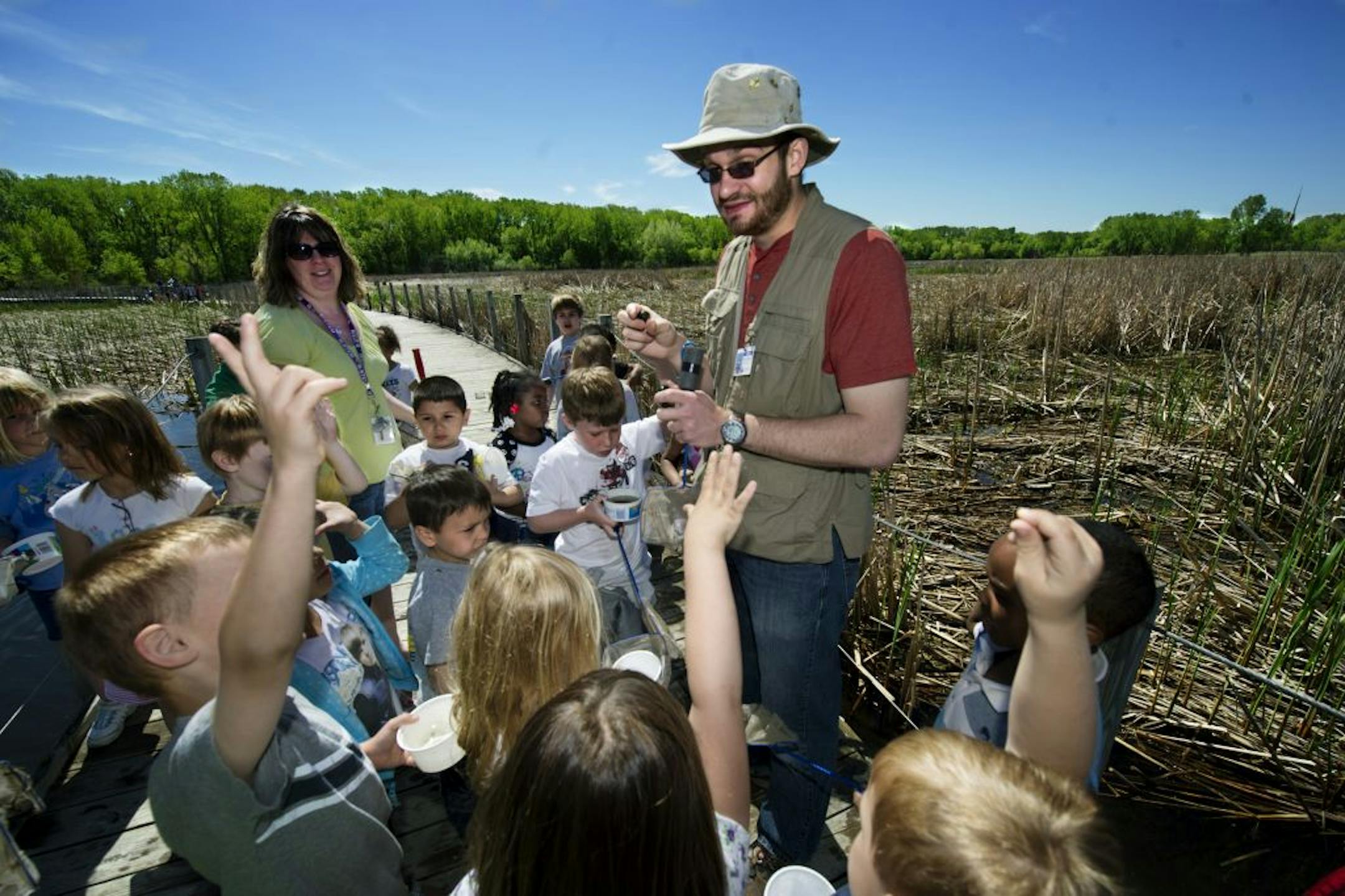 Wood Lake Nature Center naturalist Brandon Baker spoke to Michelle Gerten's kindergarten class about the smaller living things in lake that feed the ducks and turtles. The group, from the Richfield STEM school, was on the boardwalk that crosses Wood Lake.