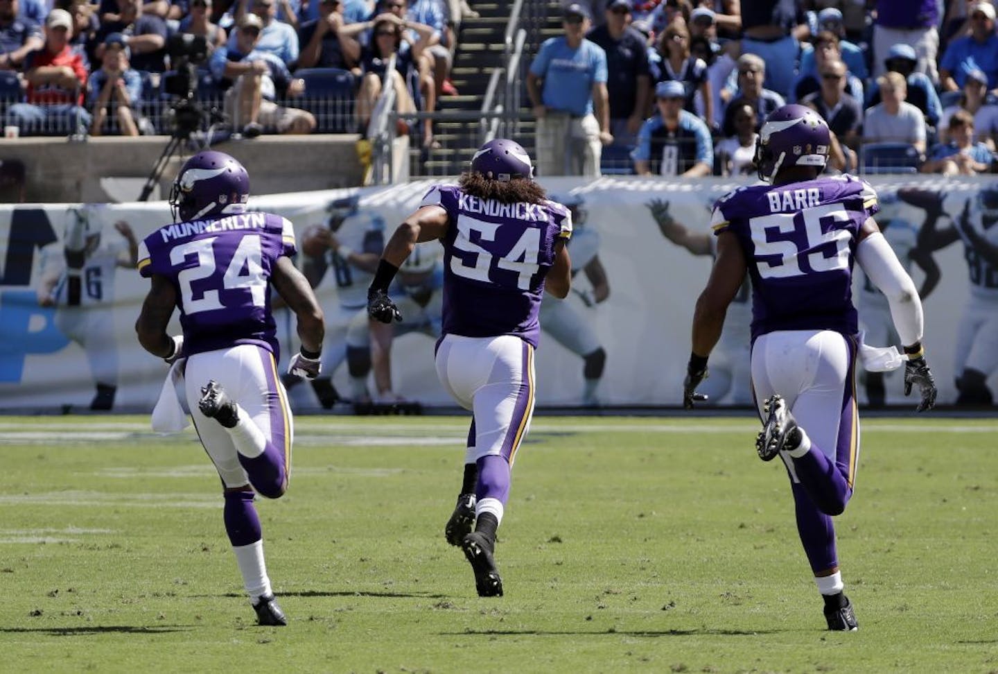 Minnesota Vikings linebacker Eric Kendricks (54) returns an intercepted pass 77 yards for a touchdown against the Tennessee Titans in the second half of an NFL football game Sunday, Sept. 11, 2016, in Nashville, Tenn. With Kendricks are Captain Munnerlyn (24) and Anthony Barr (55).