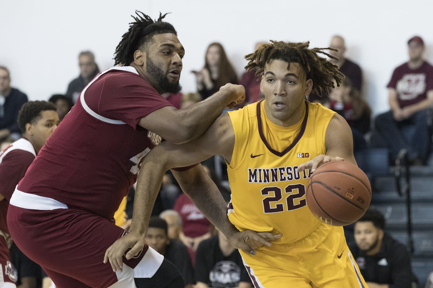 FILE - In this Friday, Nov. 24, 2017 file photo, Minnesota center Reggie Lynch (22) drives to the basket against UMass center Rashaan Holloway during the first half of an NCAA college basketball game in New York. Minnesota basketball player Reggie Lynch has been recommended for expulsion following a newly public allegation of sexual assault. The Star Tribune and the St. Paul Pioneer Press report the university's Equal Opportunity and Affirmative Action office found Lynch responsible for sexual m