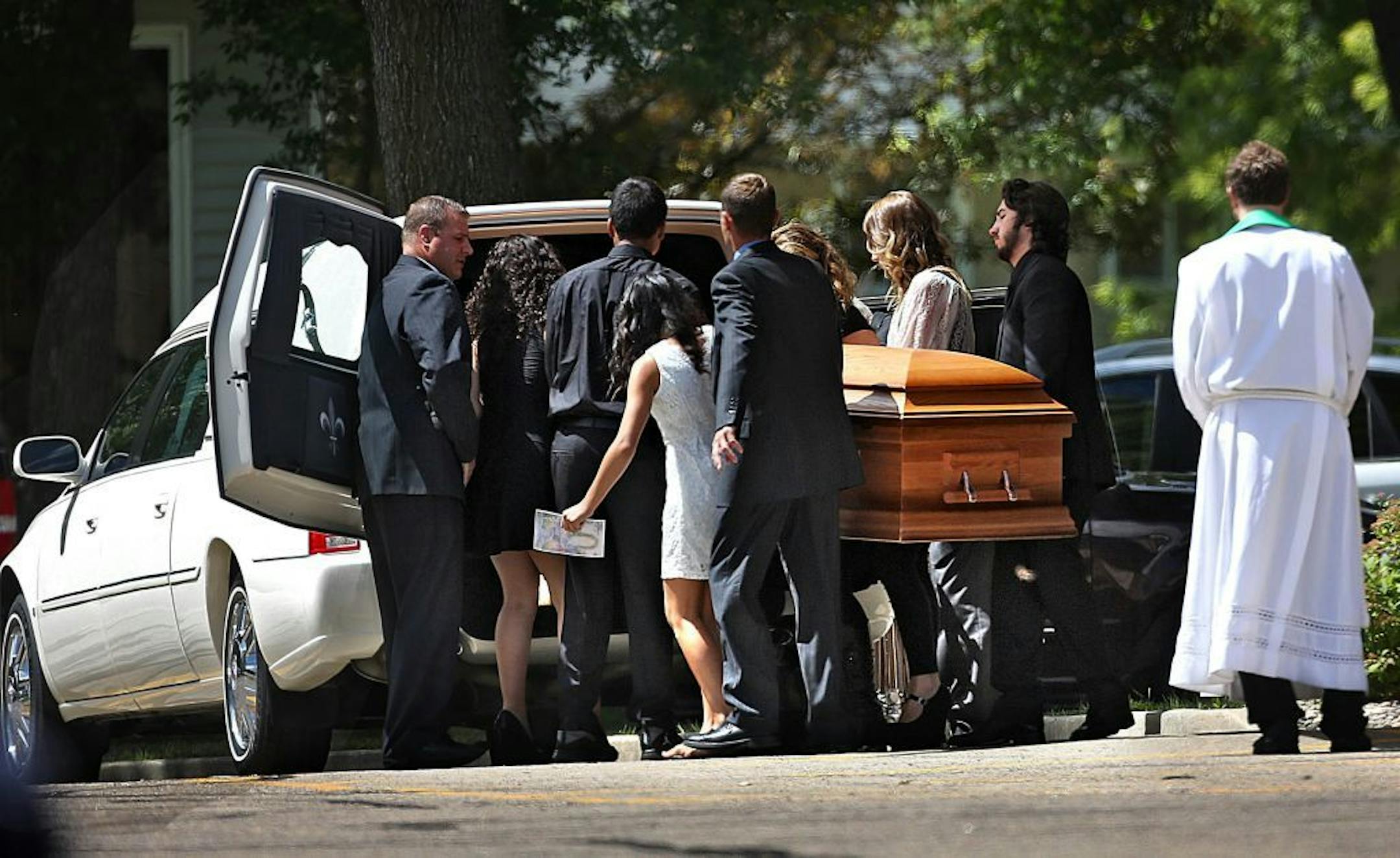Pallbearers carried the remains of Lila Warwick to a hearse following a funeral service held at Redeemer Lutheran Church Saturday.